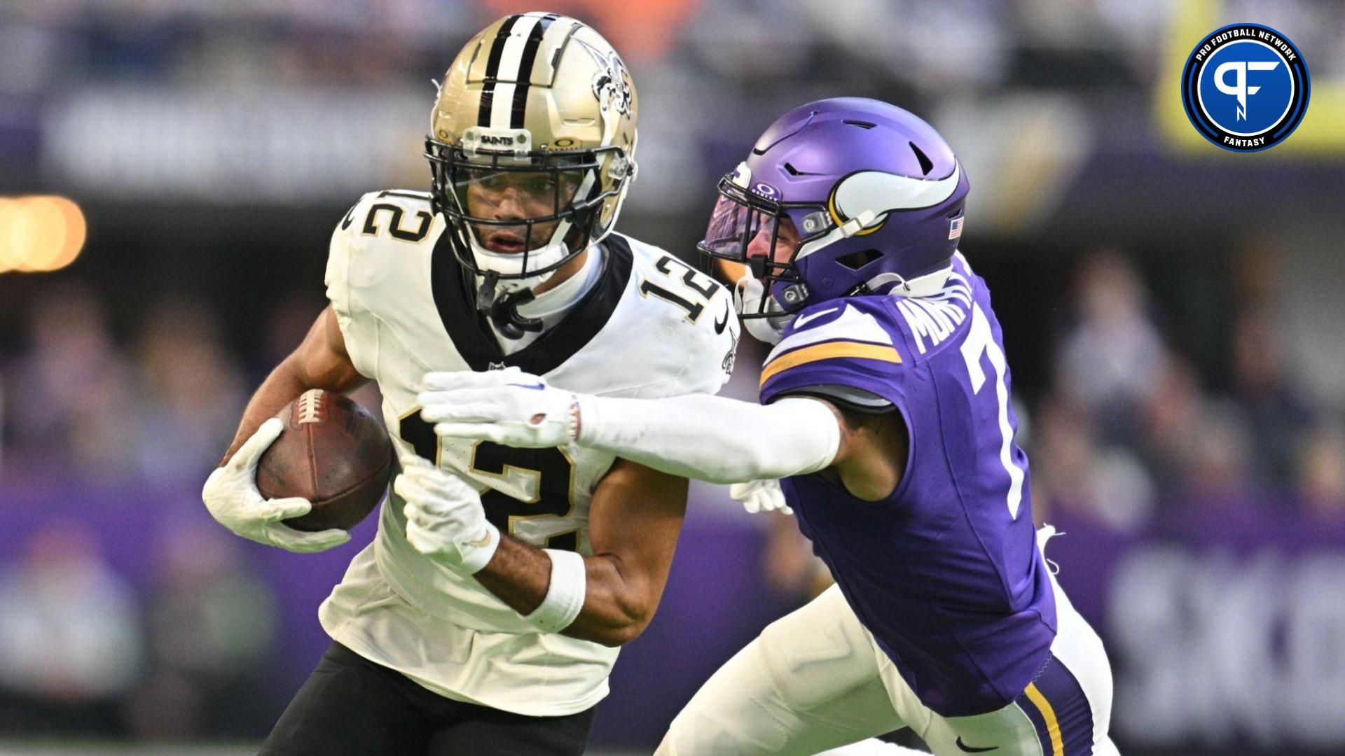 Chris Olave (12) gets yards after catch as Minnesota Vikings cornerback Byron Murphy Jr. (7) pursues during the fourth quarter at U.S. Bank Stadium.