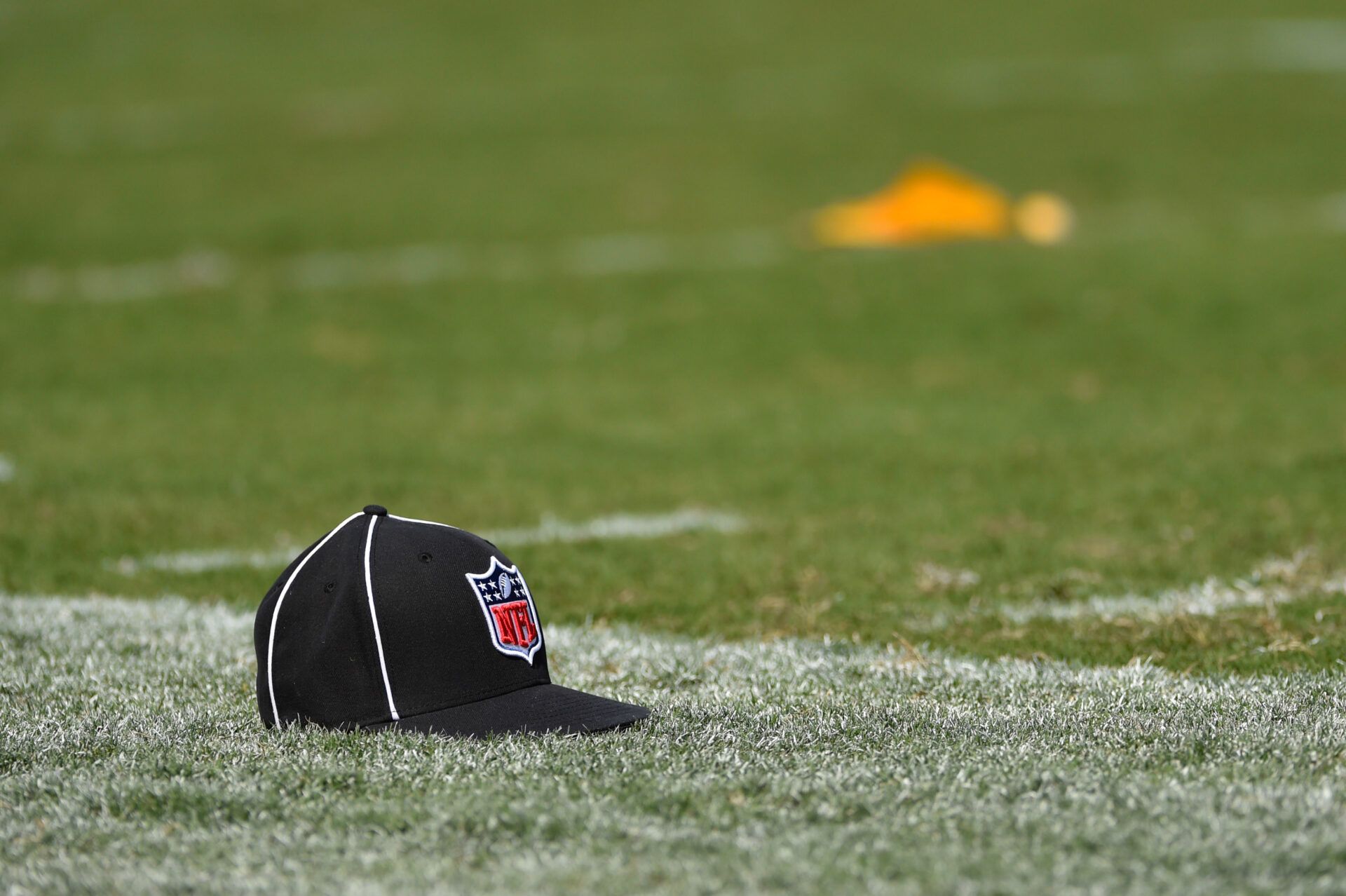 A referees hat and penalty flag sit on the field during a preseason NFL football game between the Philadelphia Eagles and the Indianapolis Colts at Lincoln Financial Field.