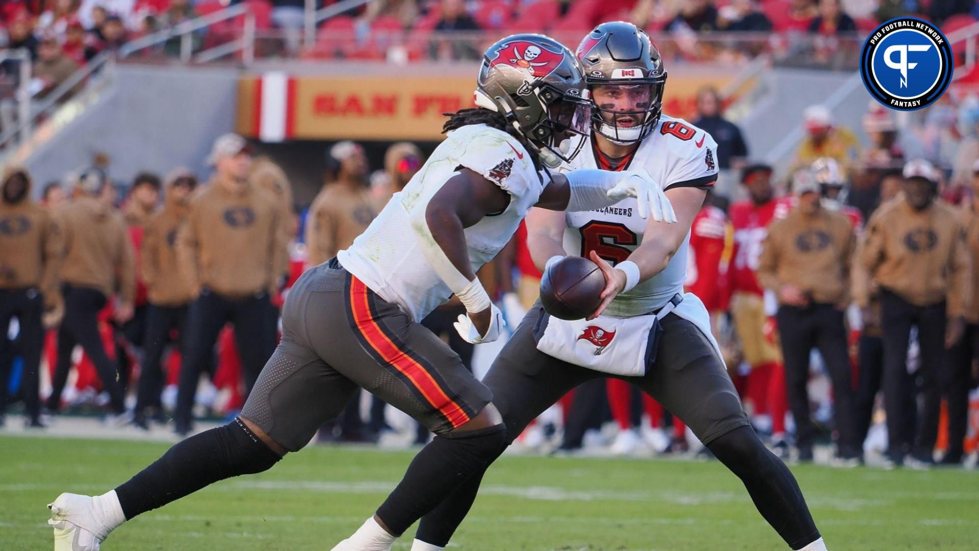 Tampa Bay Buccaneers quarterback Baker Mayfield (6) hands off the ball to Tampa Bay Buccaneers running back Rachaad White (1) for a touchdown run against the San Francisco 49ers during the fourth quarter at Levi's Stadium.