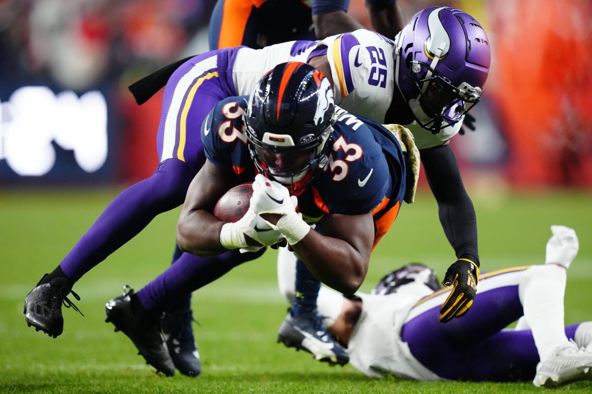 Minnesota Vikings safety Theo Jackson (25) tackles Denver Broncos running back Javonte Williams (33) in the fourth quarter at Empower Field at Mile High.