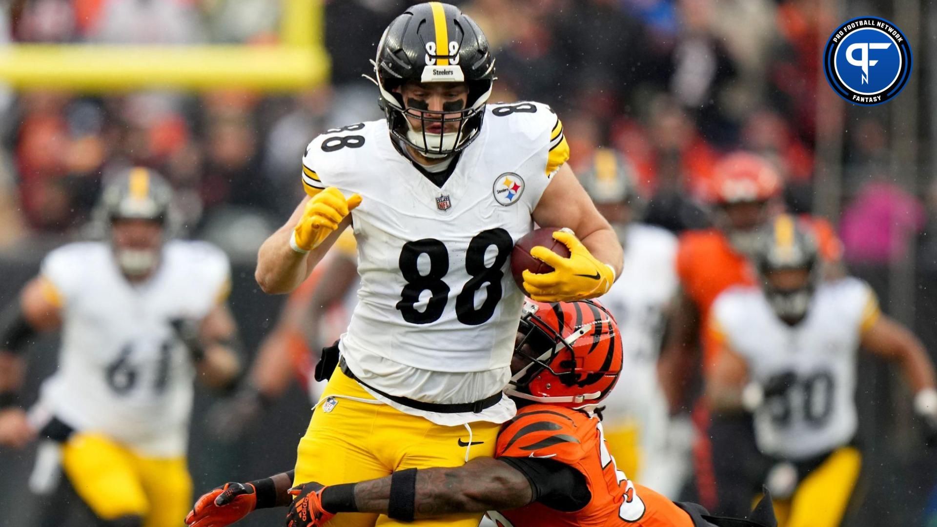 Pat Freiermuth (88) is tackled by Cincinnati Bengals safety Nick Scott (33) after a catch a in the first quarter at Paycor Stadium.