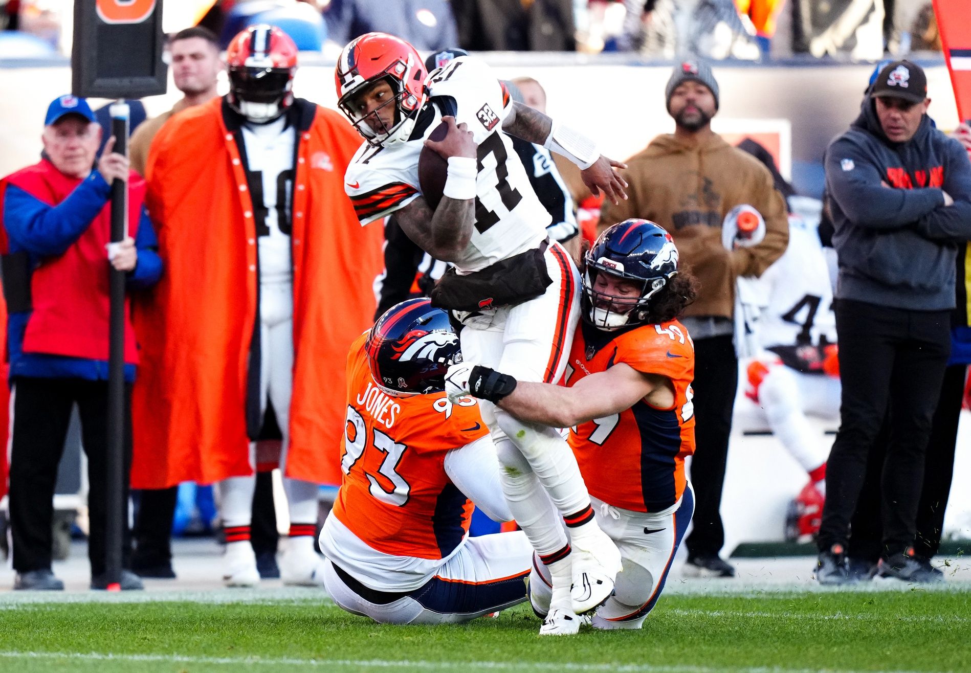 Denver Broncos linebacker Alex Singleton (49) and defensive tackle D.J. Jones (93) tackle Cleveland Browns quarterback Dorian Thompson-Robinson (17) in the second quarter at Empower Field at Mile High.