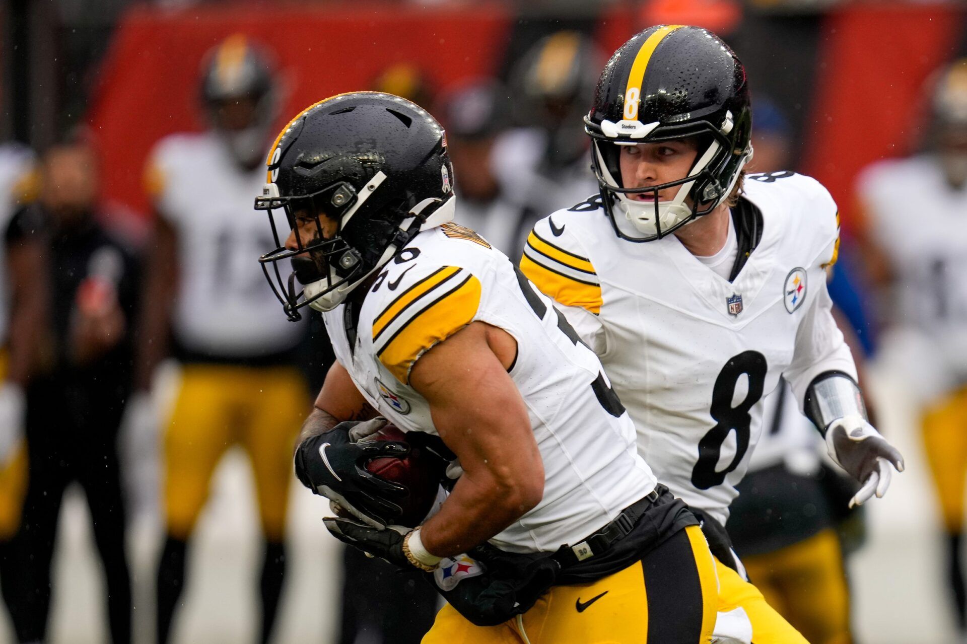 Kenny Pickett (8) hands off to running back Jaylen Warren (30) in the second quarter of the NFL Week 12 game between the Cincinnati Bengals and the Pittsburgh Steelers at Paycor Stadium.