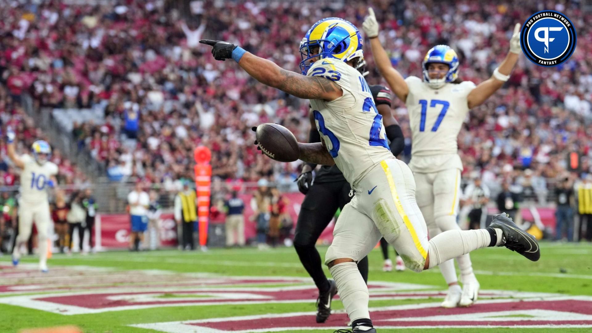 Los Angeles Rams running back Kyren Williams (23) runs for a touchdown against the Arizona Cardinals during the first half at State Farm Stadium.