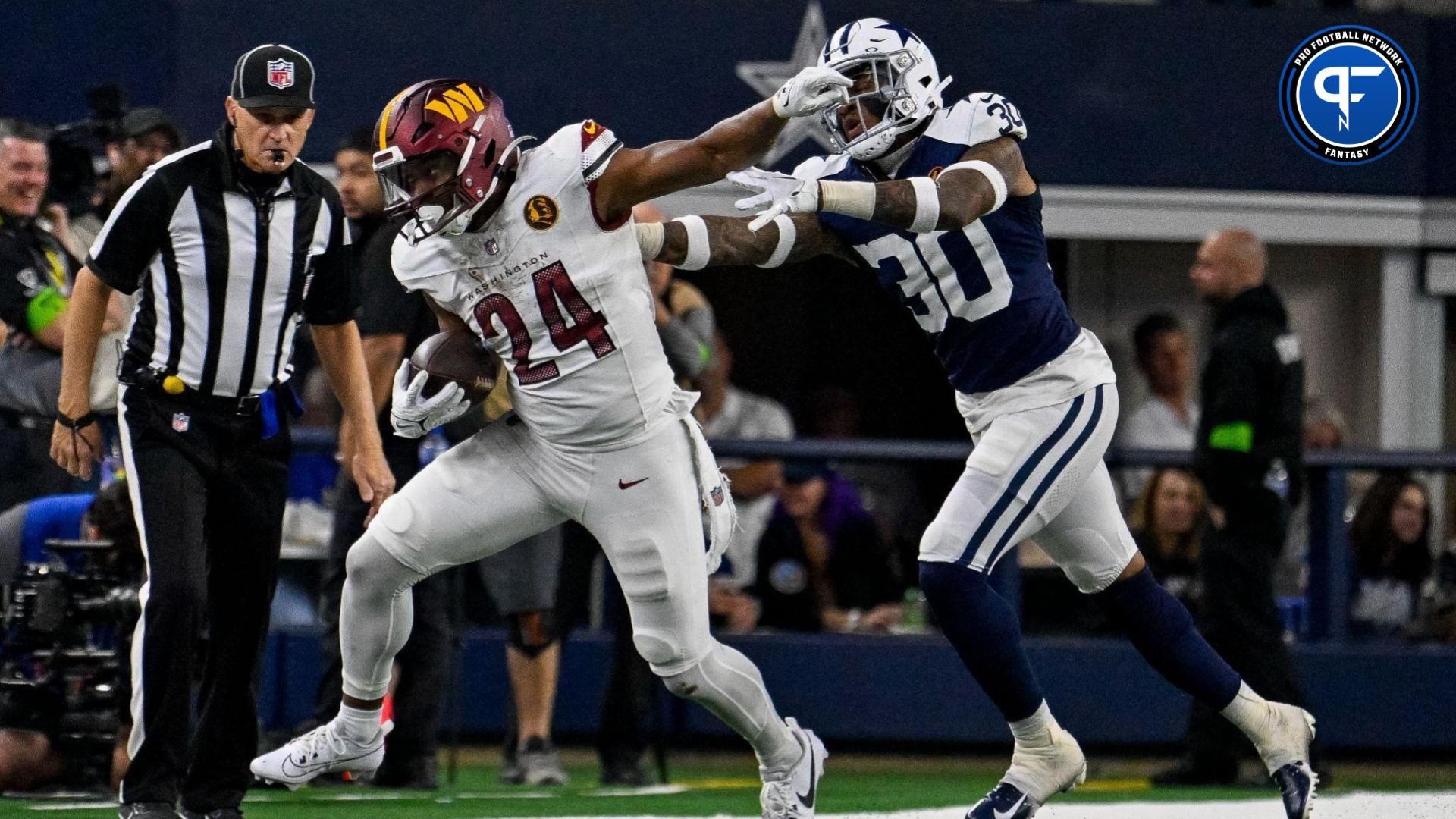 Washington Commanders running back Antonio Gibson (24) and Dallas Cowboys safety Juanyeh Thomas (30) in action during the game between the Dallas Cowboys and the Washington Commanders at AT&T Stadium.