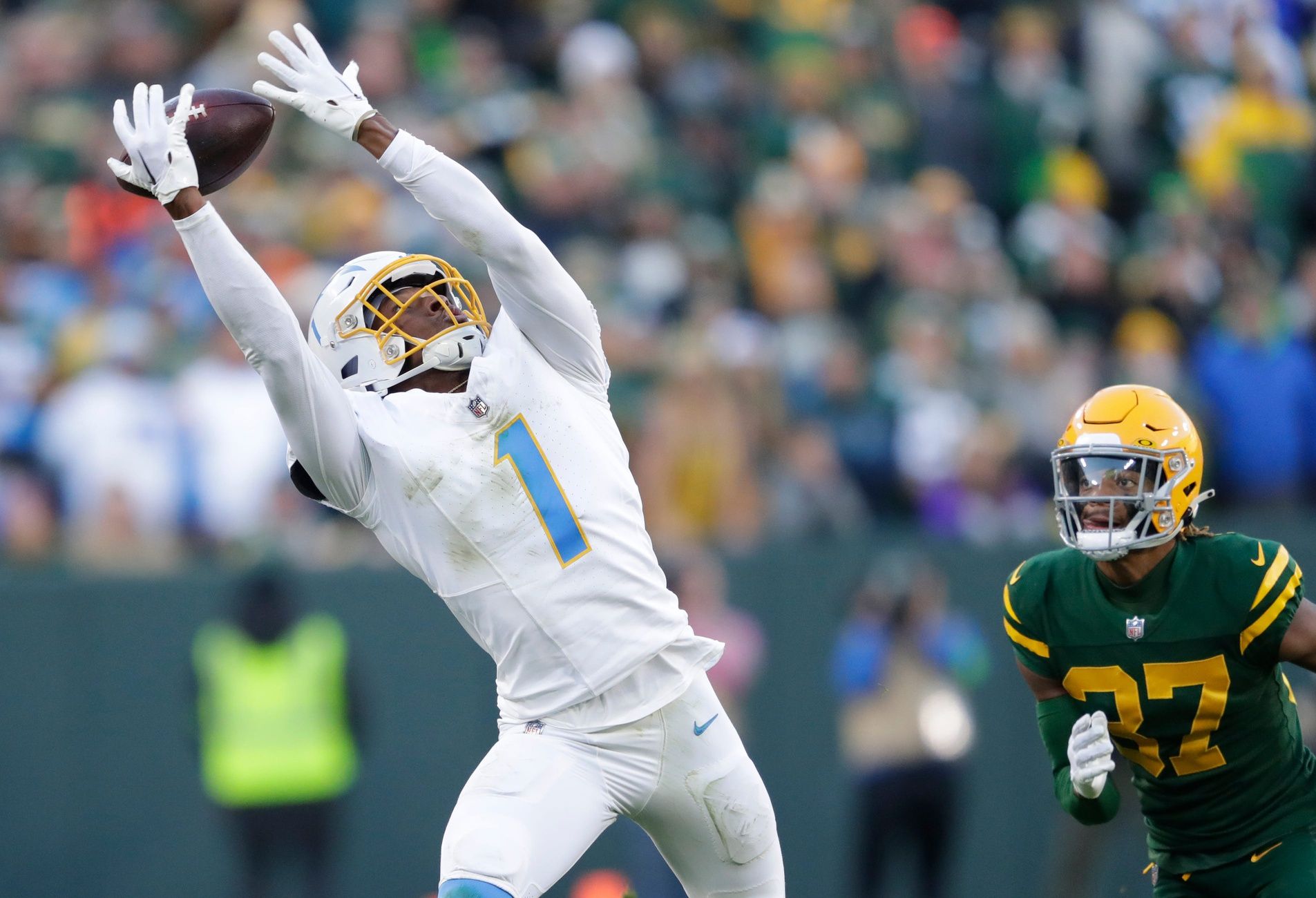 Quentin Johnston (1) drops a pass late in the fourth quarter after getting past Green Bay Packers cornerback Carrington Valentine (37).