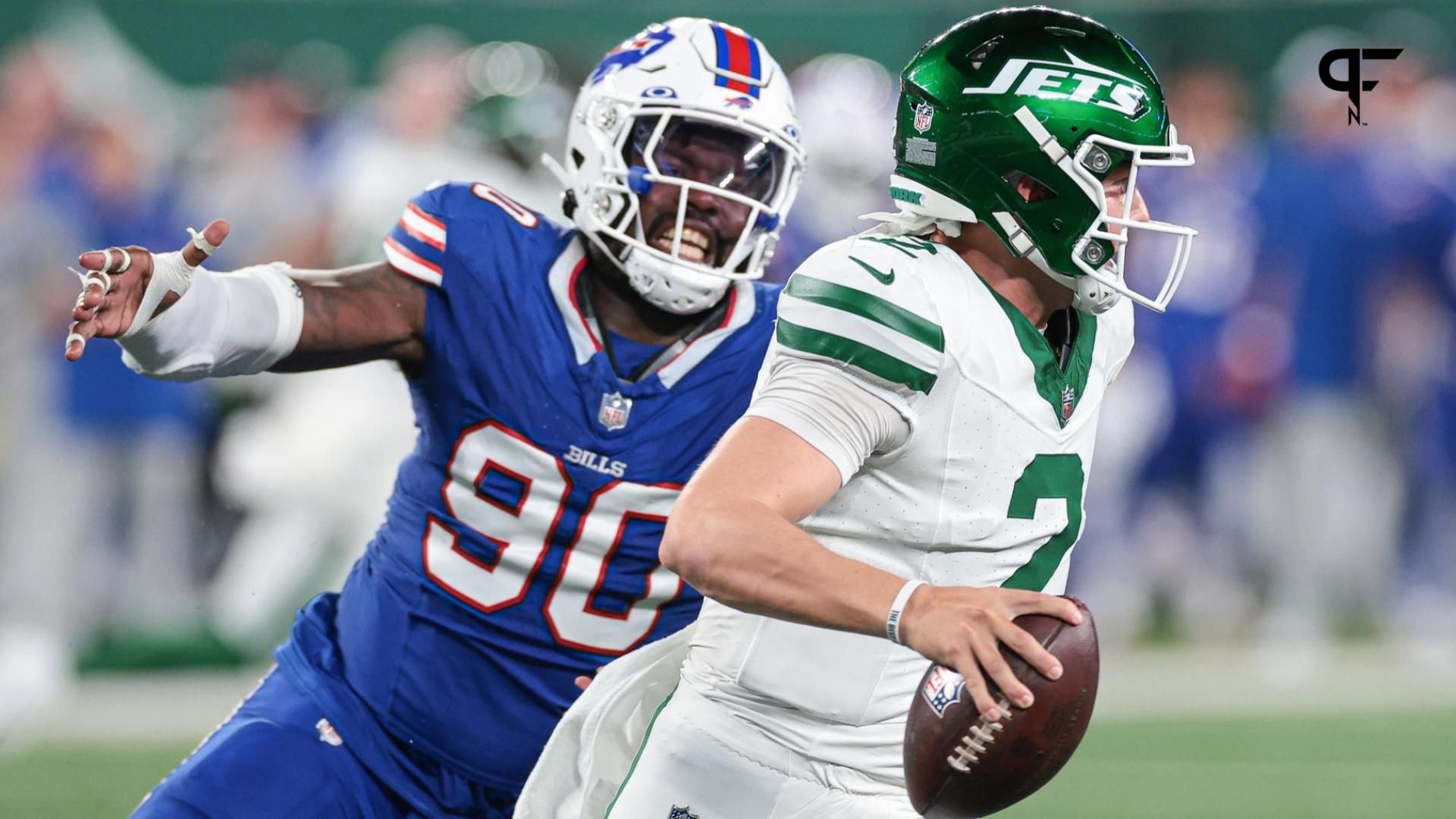 New York Jets quarterback Zach Wilson (2) avoids being sacked by Buffalo Bills defensive end Shaq Lawson (90) during the second half at MetLife Stadium.