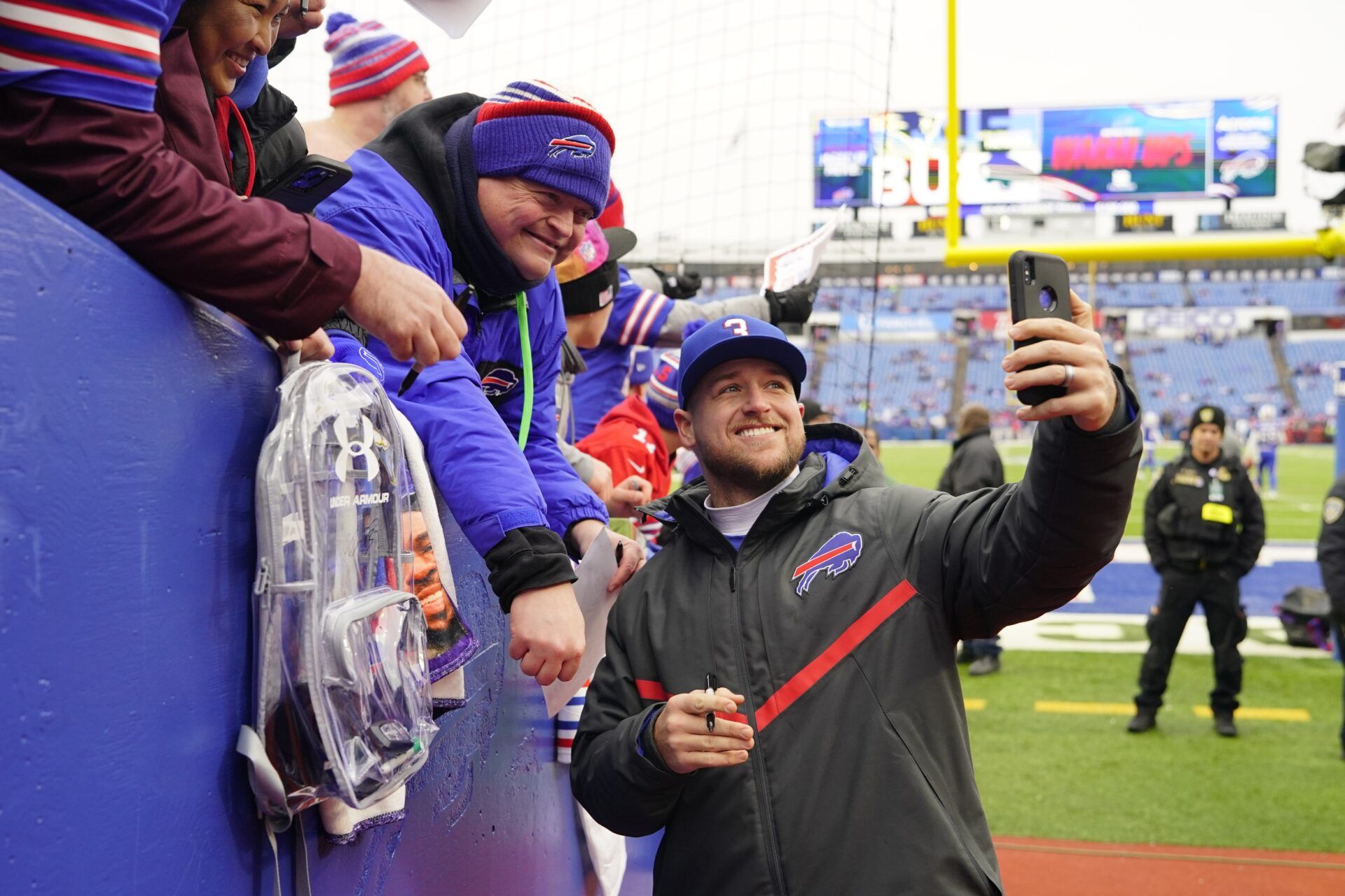 Buffalo Bills quarterbacks coach Joe Brady poses for a picture with fans prior to the game against the New England Patriots.