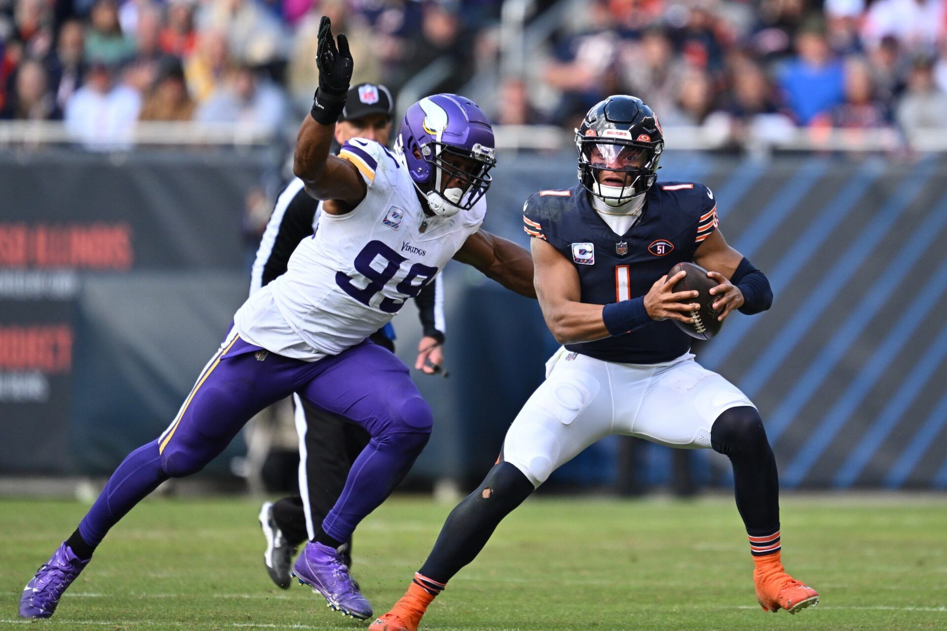 Chicago Bears QB Justin Fields (1) tries to escape Minnesota Vikings LB Danielle Hunter (99).