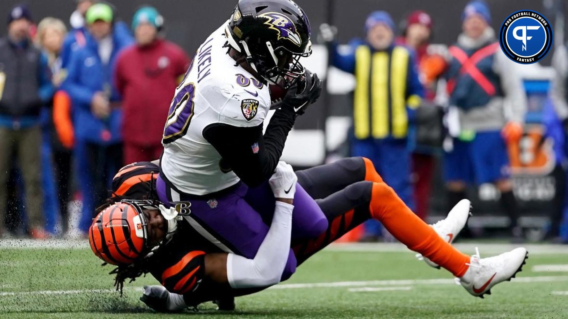 Baltimore Ravens TE Isaiah Likely (80) gets tackled by Cincinnati Bengals CB Tre Flowers (33).