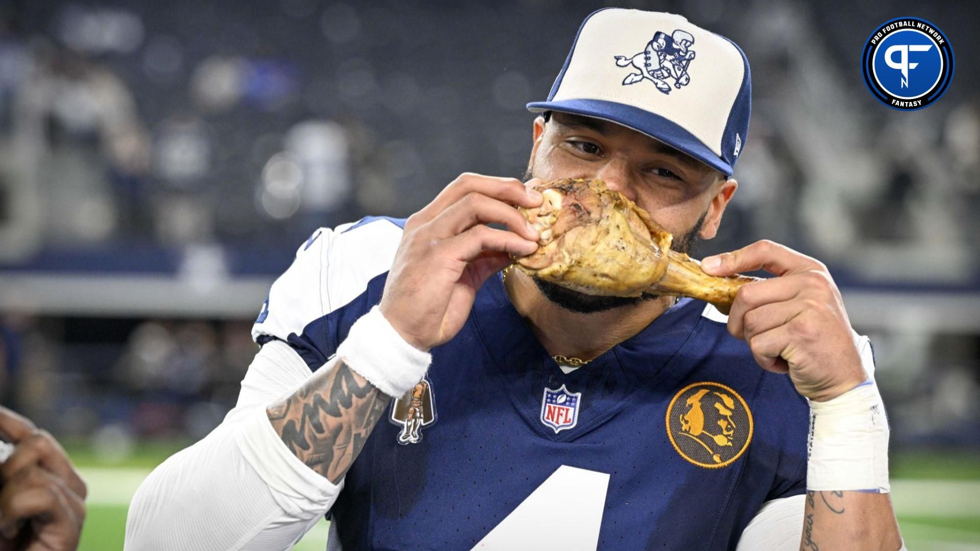 Dallas Cowboys Dak Prescott (4) eats a turkey leg after the Cowboys victory over the Washington Commanders at AT&T Stadium.