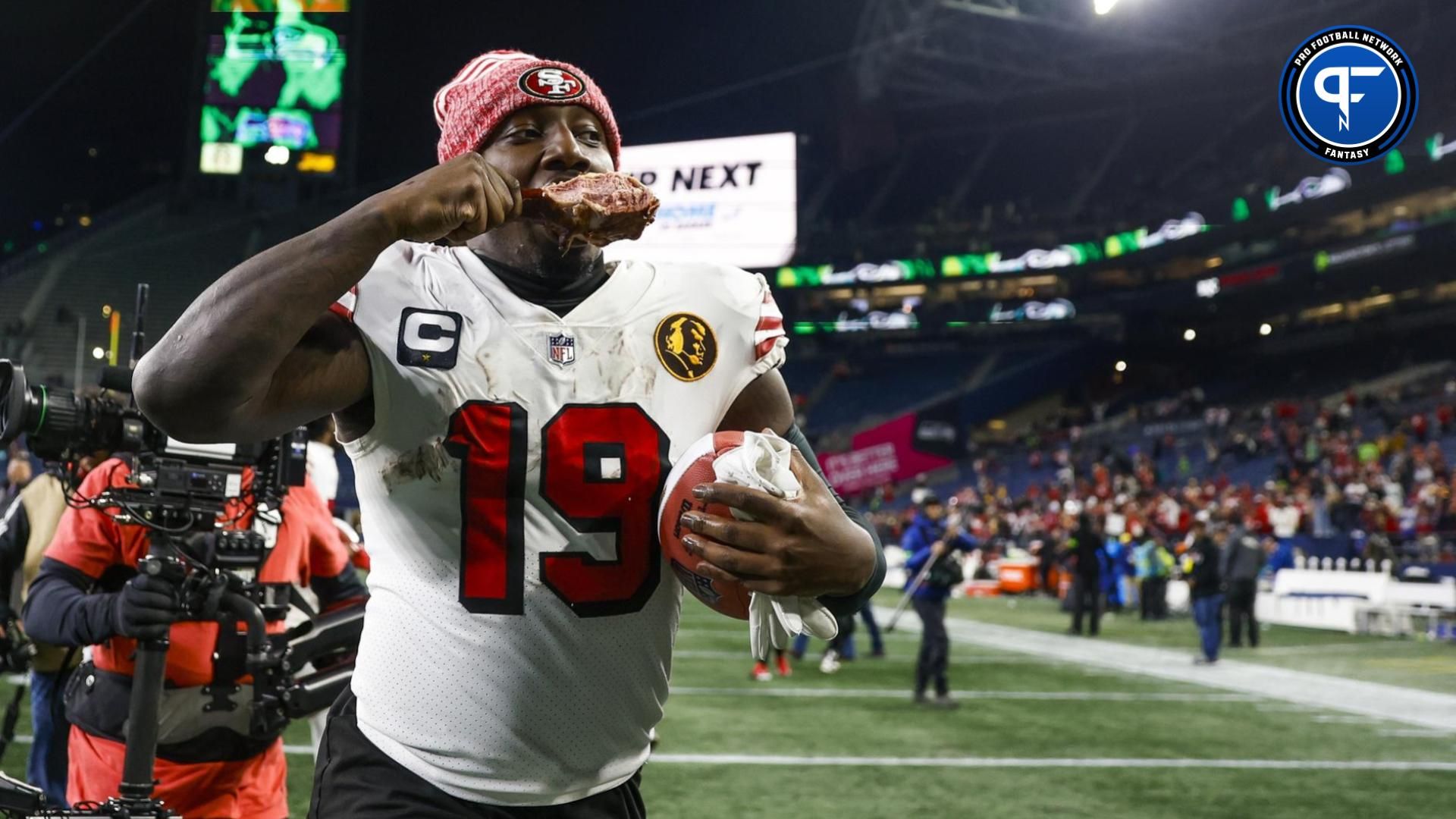 Deebo Samuel (19) eats a turkey leg as he jogs to the locker room following a 31-13 victory against the Seattle Seahawks at Lumen Field.