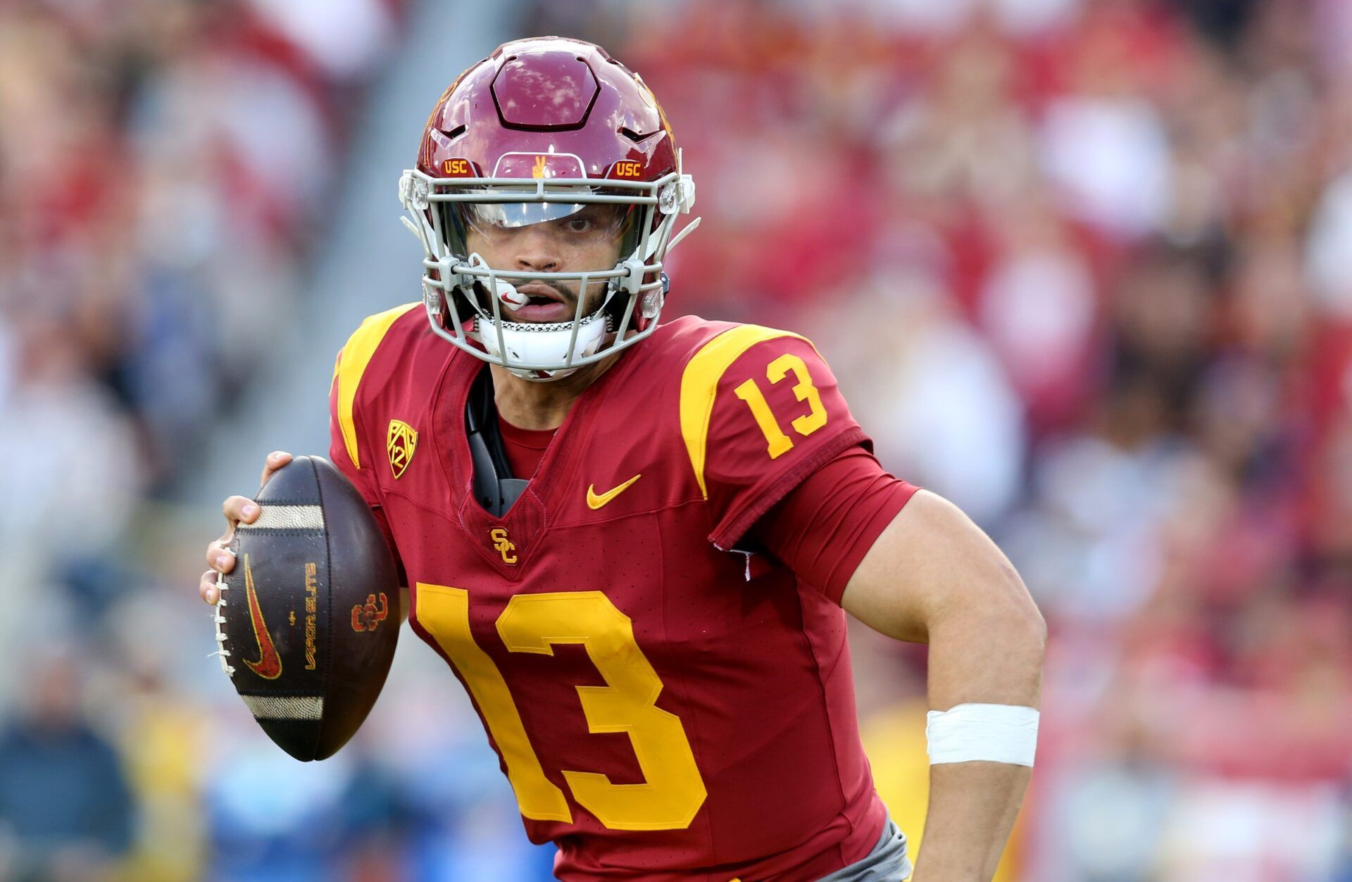 Caleb Williams (13) scrambles during the second quarter against the UCLA Bruins at United Airlines Field at Los Angeles Memorial Coliseum.