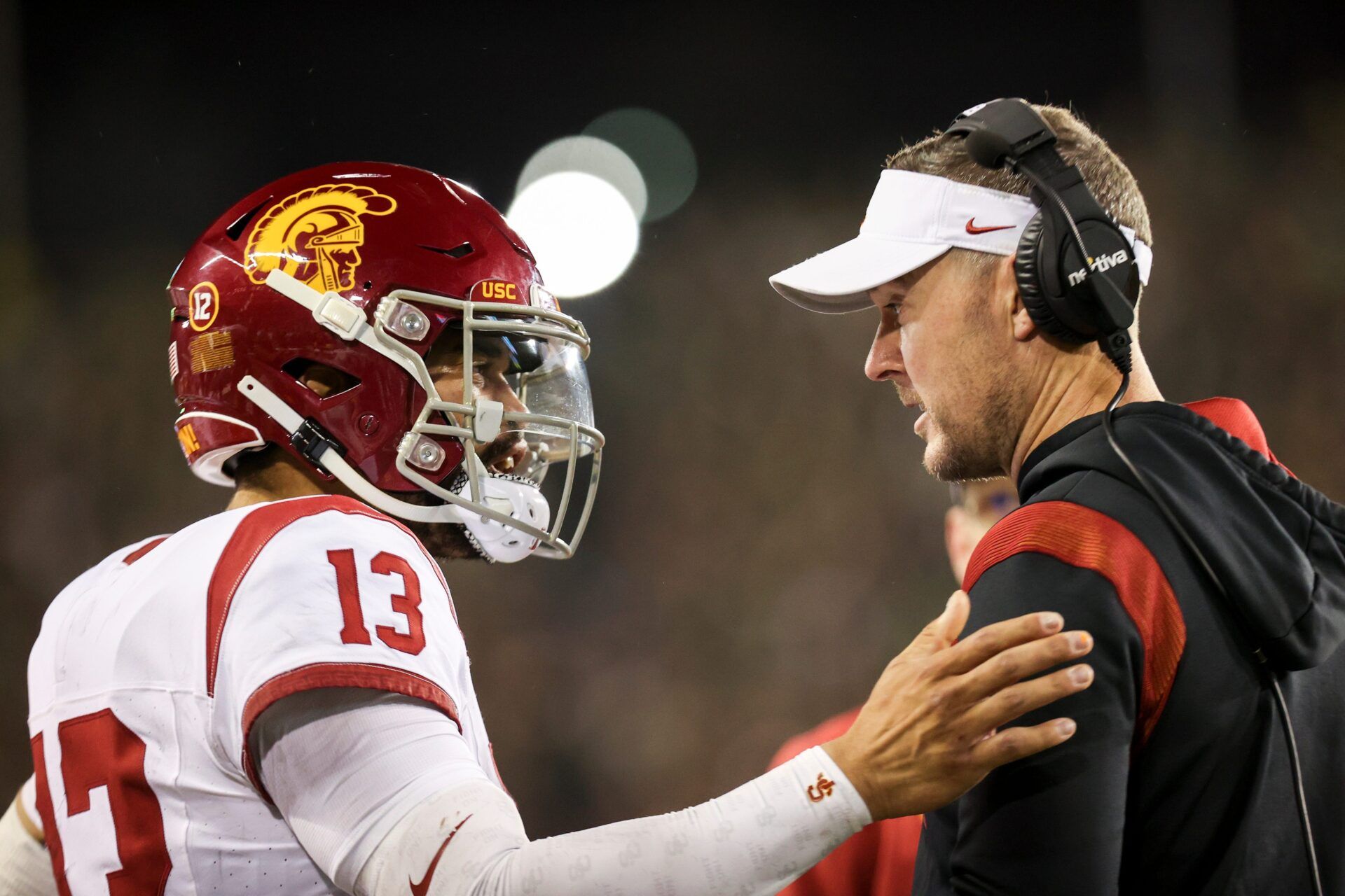 USC QB Caleb Williams (13) talks with head coach Lincoln Riley.