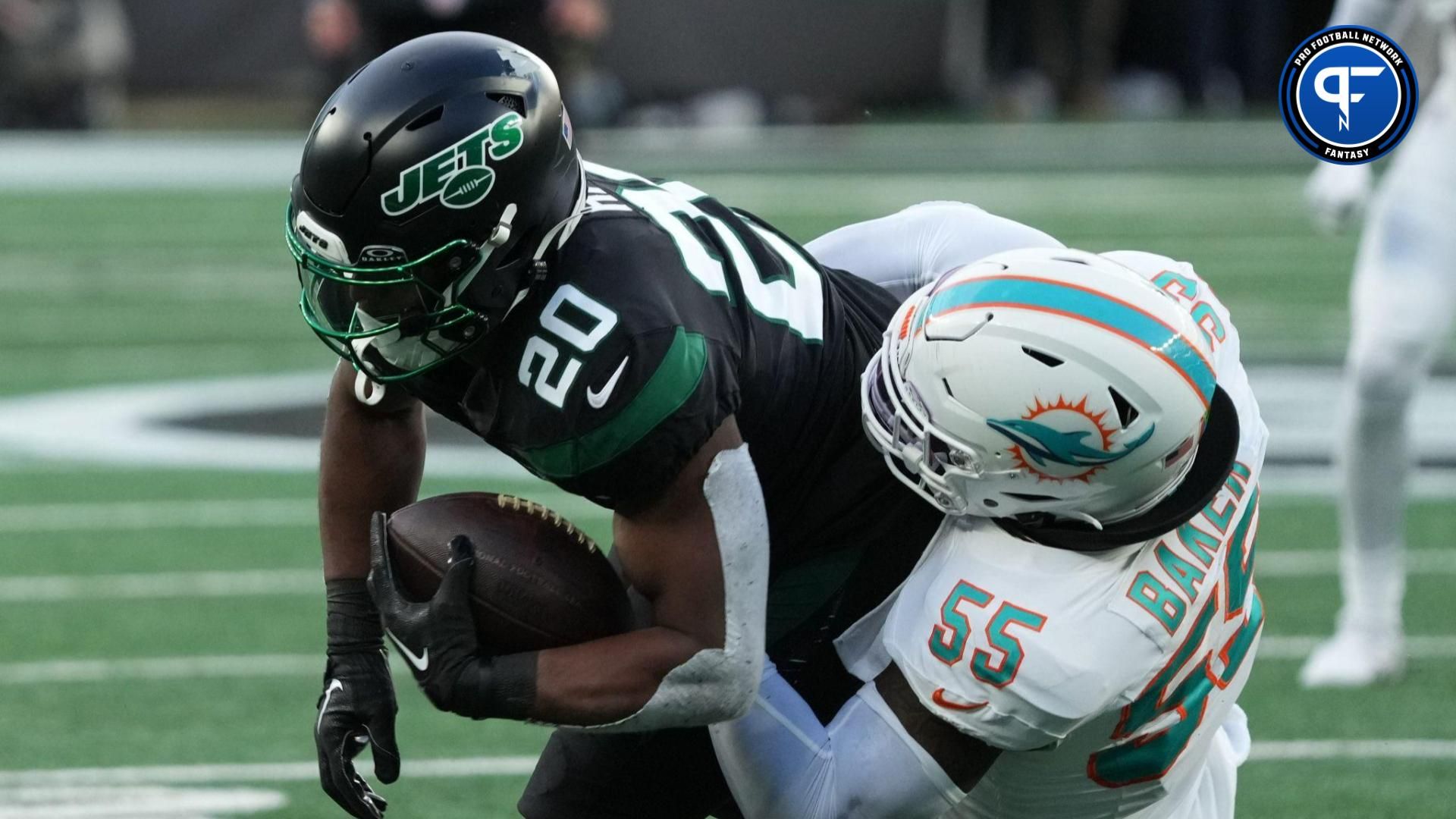 Breece Hall of the Jets is tackled by Jerome Baker of Miami in the first half as the Miami Dolphins defeated the NY Jets 34-13 at MetLife Stadium