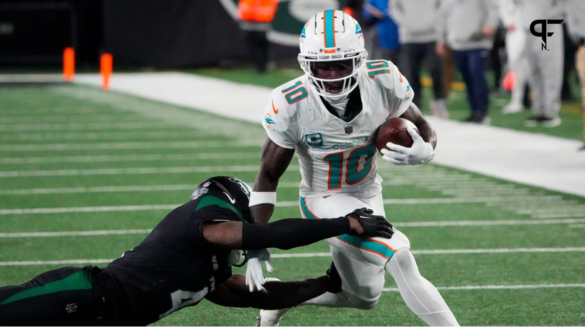 Miami Dolphins wide receiver Tyreek Hill (10) is tackled by New York Jets cornerback D.J. Reed (4) in the second half at MetLife Stadium.