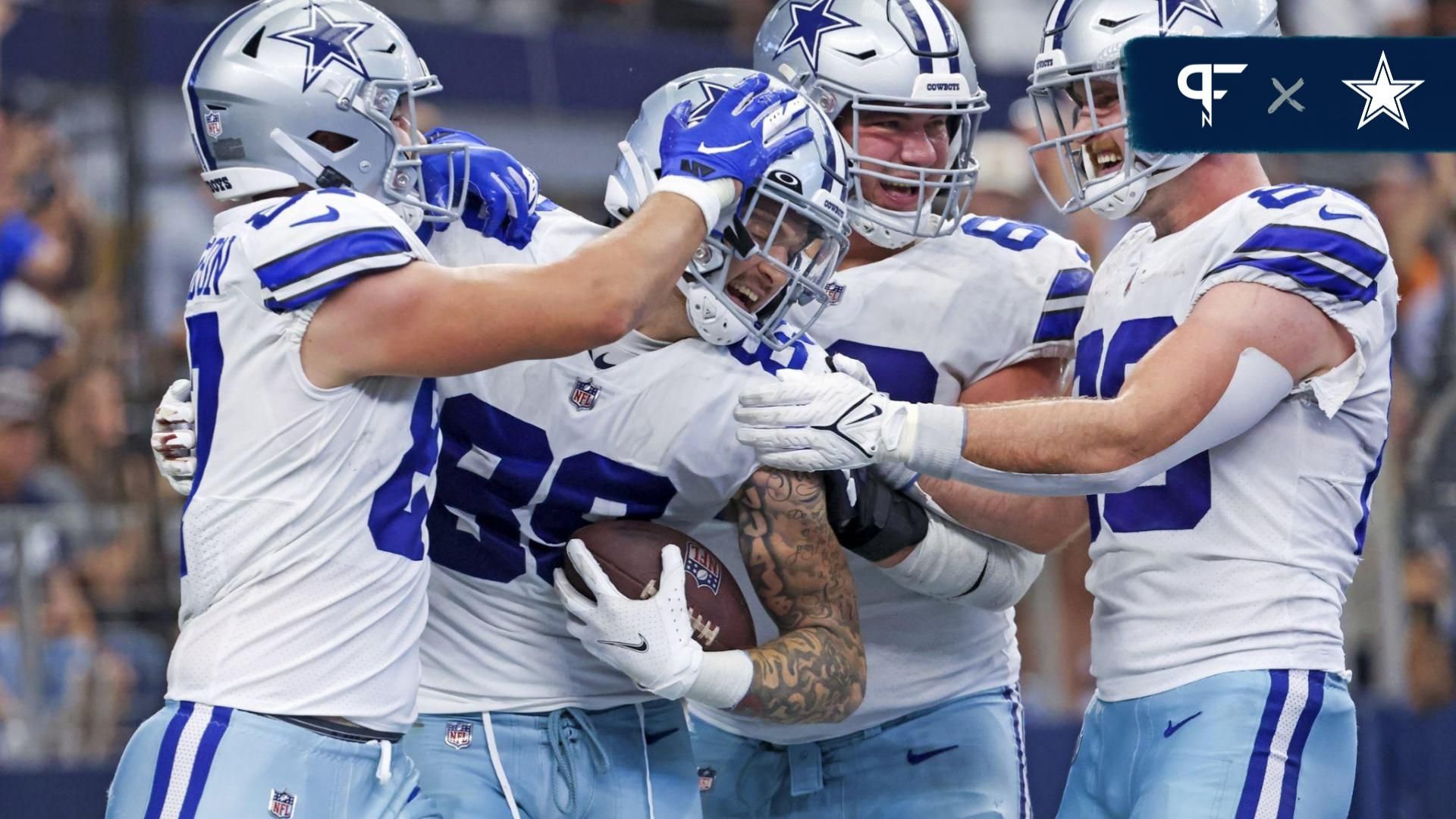 Peyton Hendershot (89) celebrates with teammates after catching a touchdown pass during the fourth quarter against the Detroit Lions at AT&T Stadium.