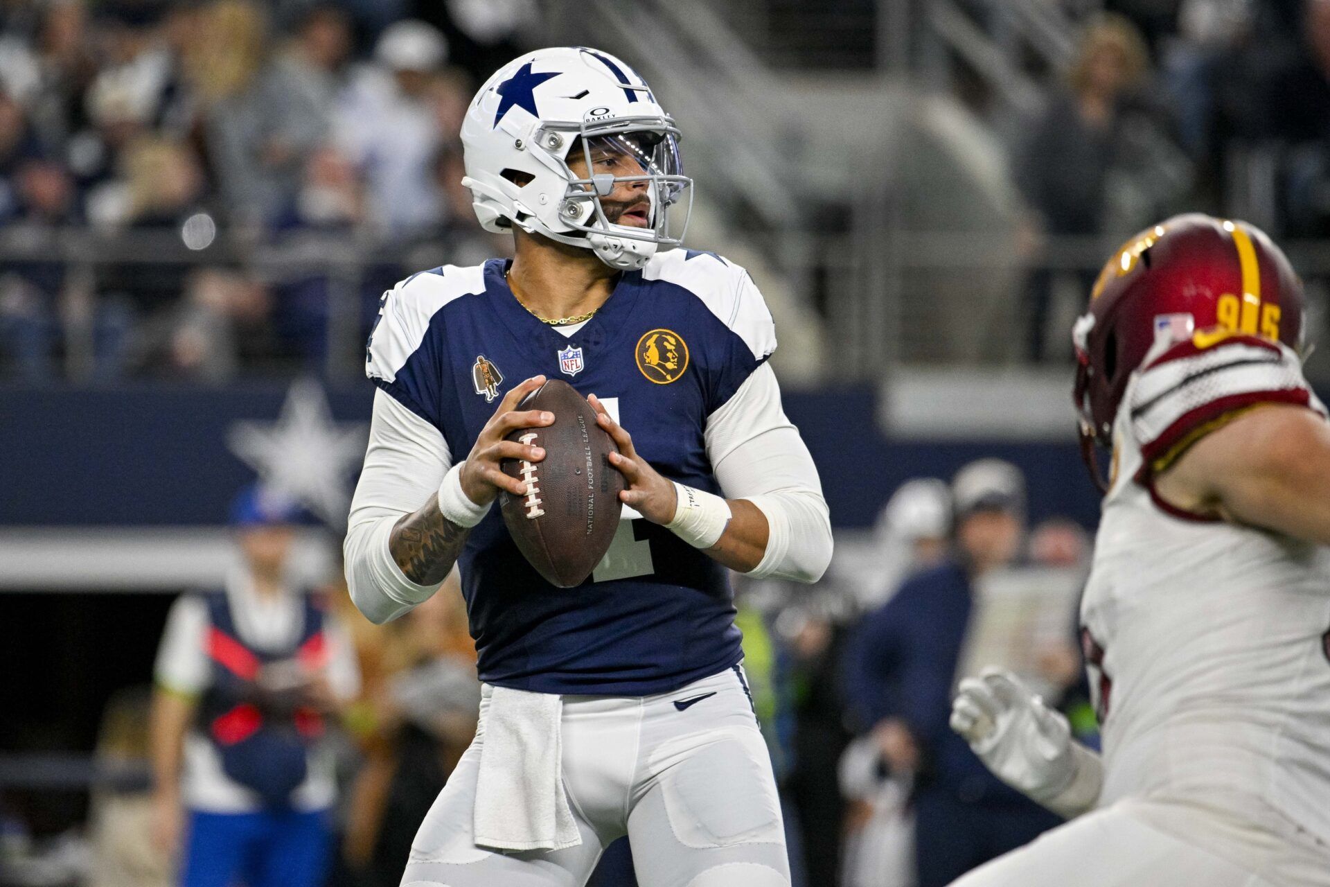 Dallas Cowboys quarterback Dak Prescott (4) drops back to pass against the Washington Commanders during the second quarter at AT&T Stadium.