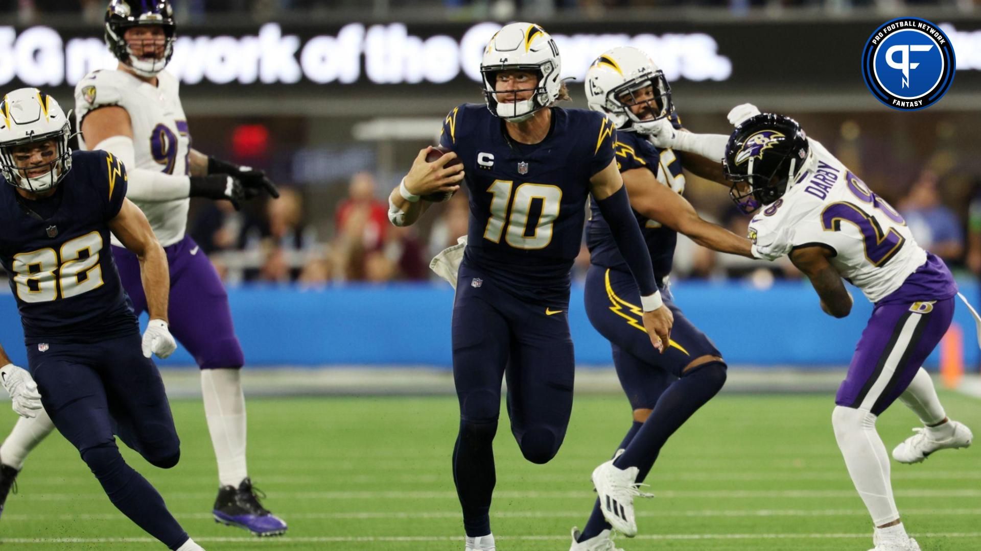 Los Angeles Chargers quarterback Justin Herbert (10) scrambles for a 35-yard run during the fourth quarter against the Baltimore Ravens at SoFi Stadium.