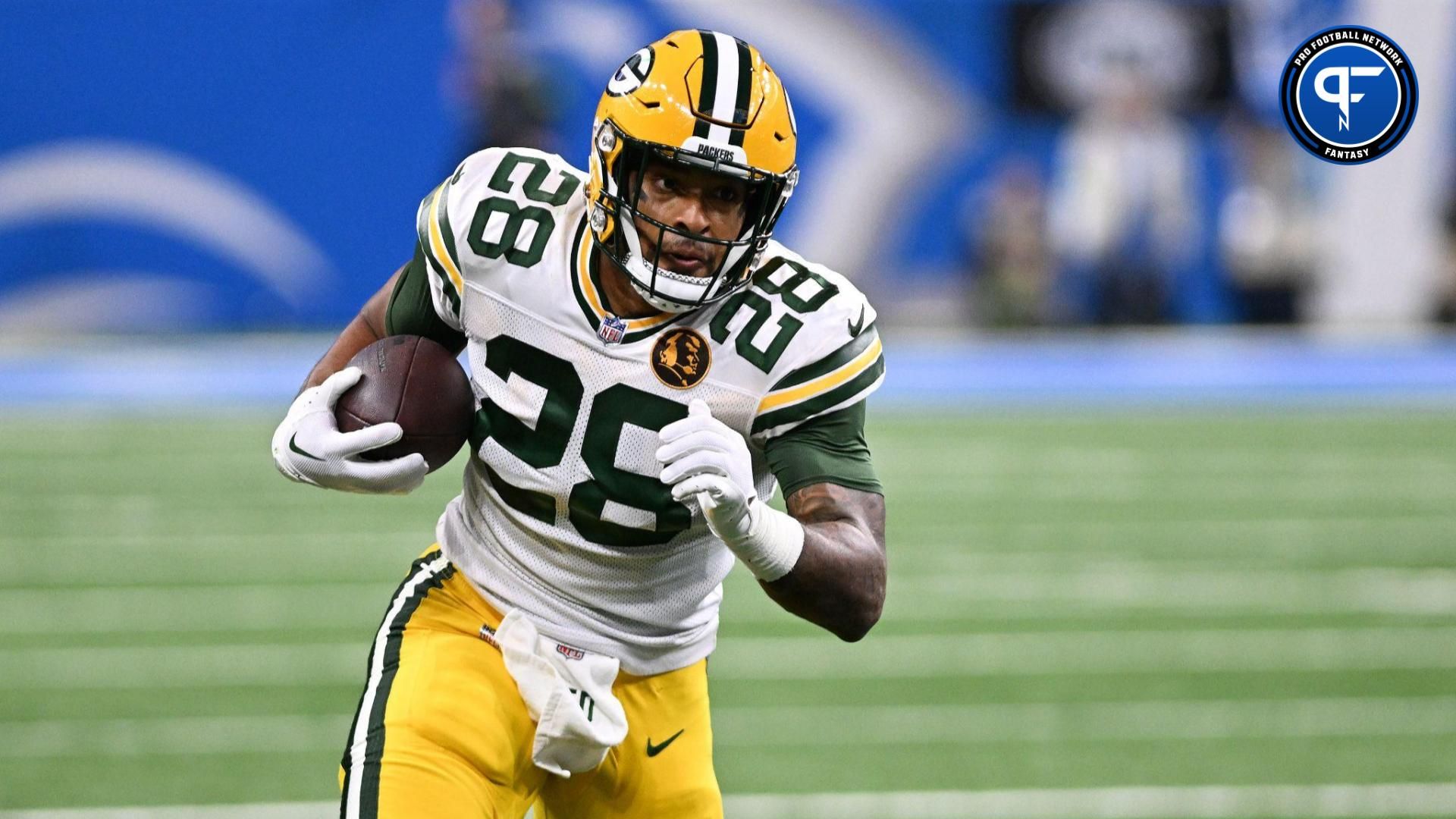 Green Bay Packers running back AJ Dillon (28) runs the ball against the Detroit Lions in the first quarter at Ford Field.