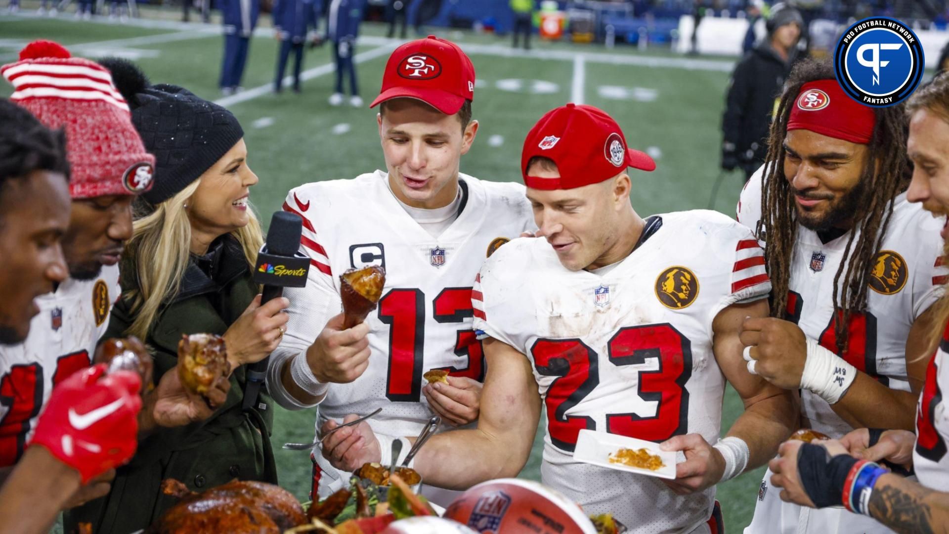 Brock Purdy (13), running back Christian McCaffrey (23) and San Francisco 49ers linebacker Fred Warner (54) partake in a turkey dinner following a 31-13 victory against the Seattle Seahawks at Lumen Field.