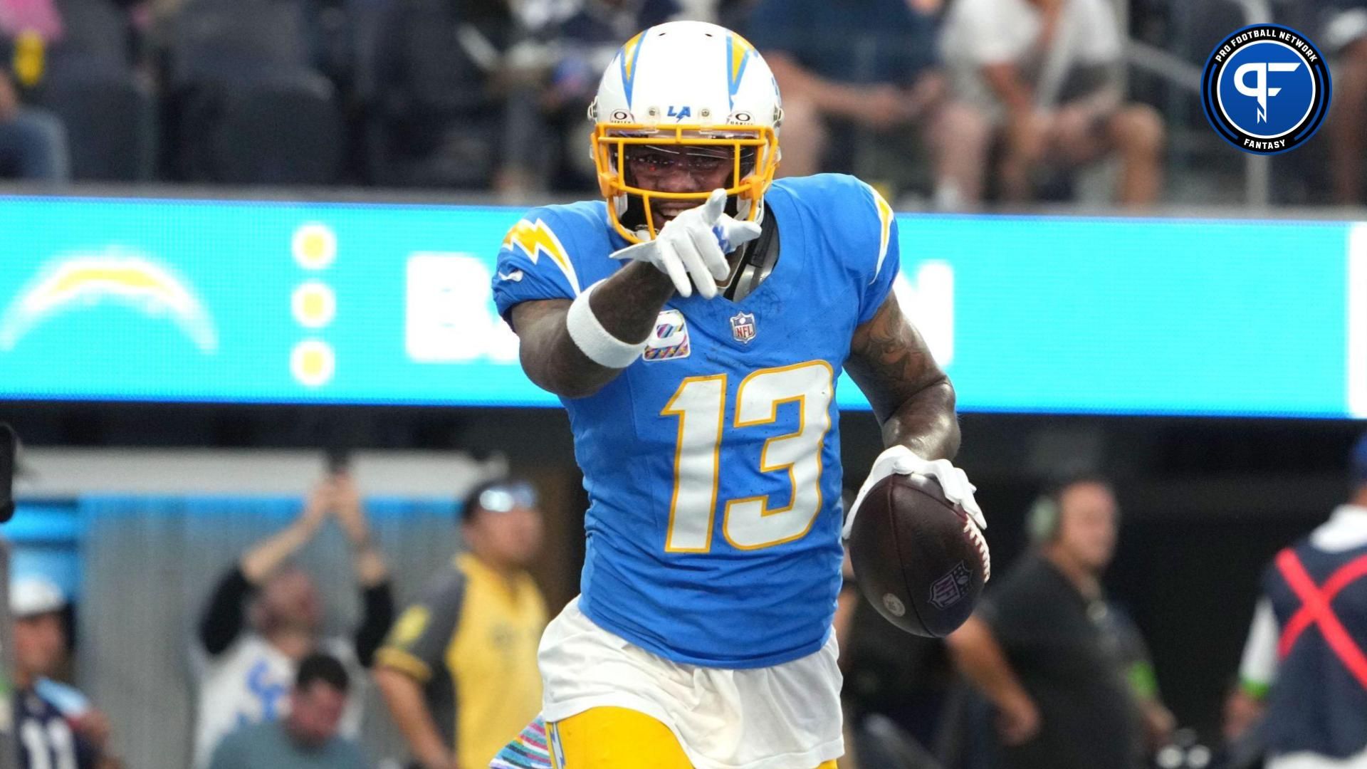 Keenan Allen (13) celebrates after scoring on a 1-yard touchdown reception against the Dallas Cowboys in the first half at SoFi Stadium.