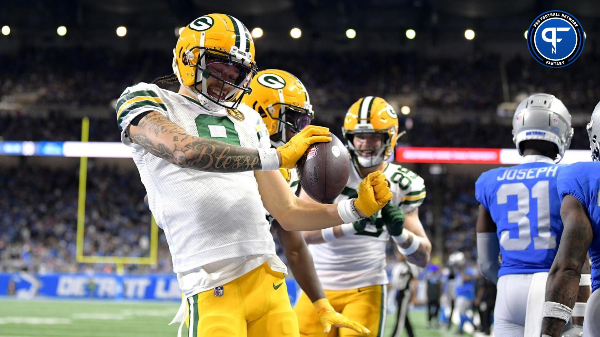 Christian Watson (9) celebrates after scoring a touchdown against the Detroit Lions in the third quarter at Ford Field.