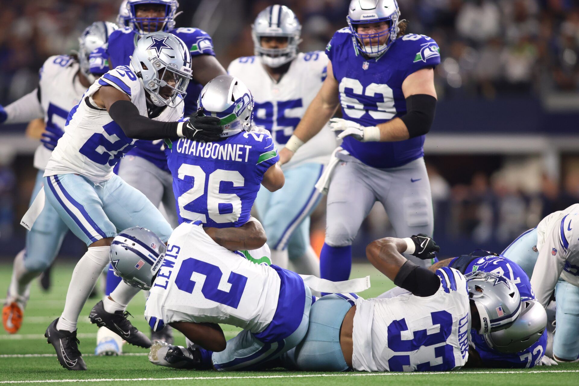 Seattle Seahawks running back Zach Charbonnet (26) is tackled by Dallas Cowboys cornerback Jourdan Lewis (2).