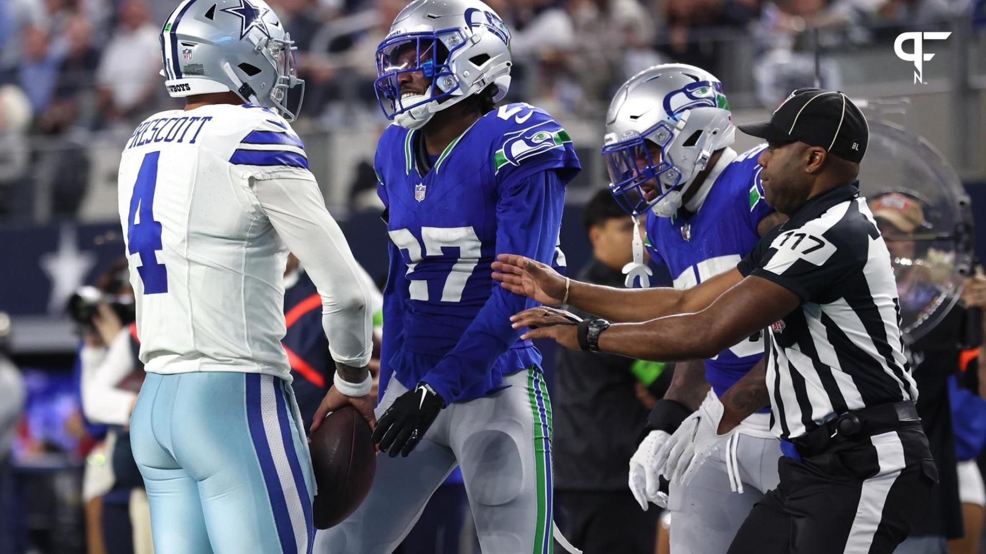 Dallas Cowboys quarterback Dak Prescott (4) and Seattle Seahawks cornerback Riq Woolen (27) talk after a play during the second half at AT&T Stadium.