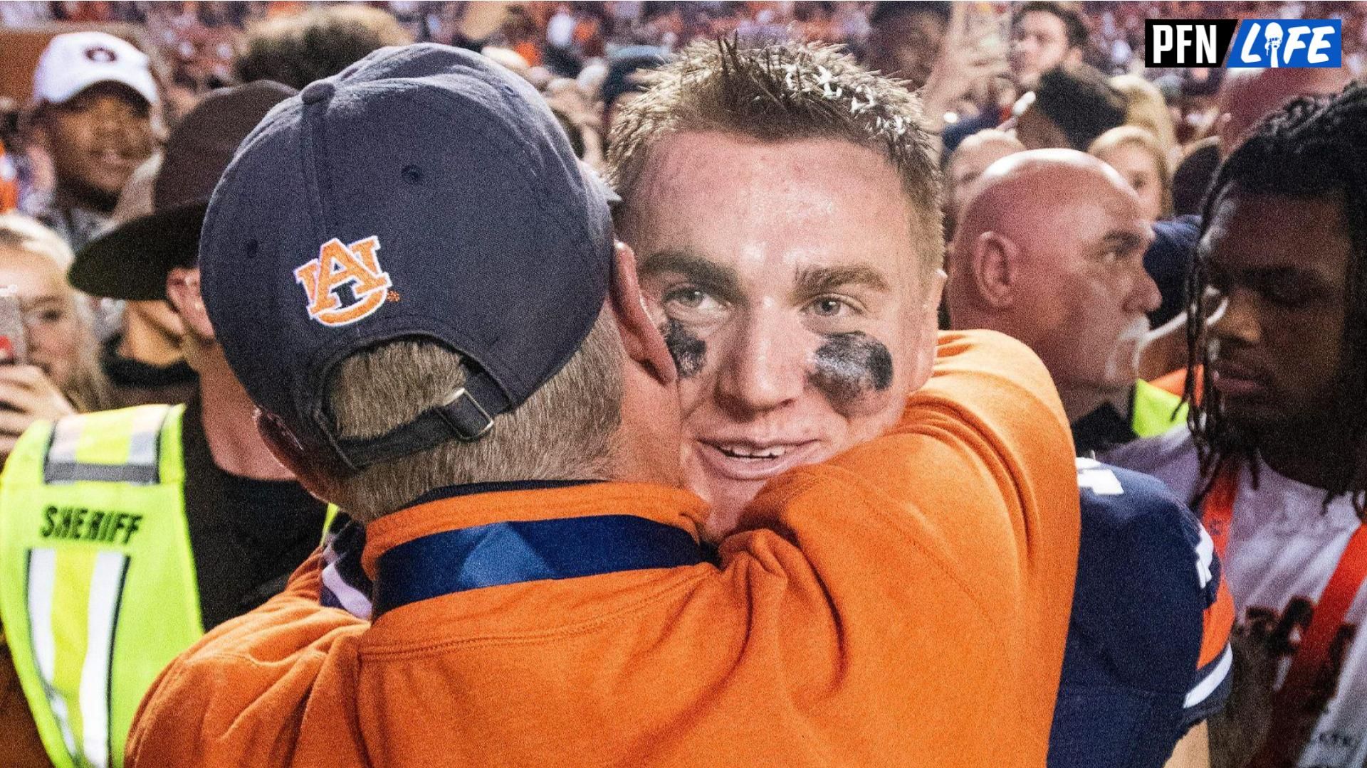 Auburn quarterback Bo Nix (10) hugs his father former Auburn quarterback Patrick Nix after defeating Alabama in the Iron Bowl at Jordan-Hare Stadium.