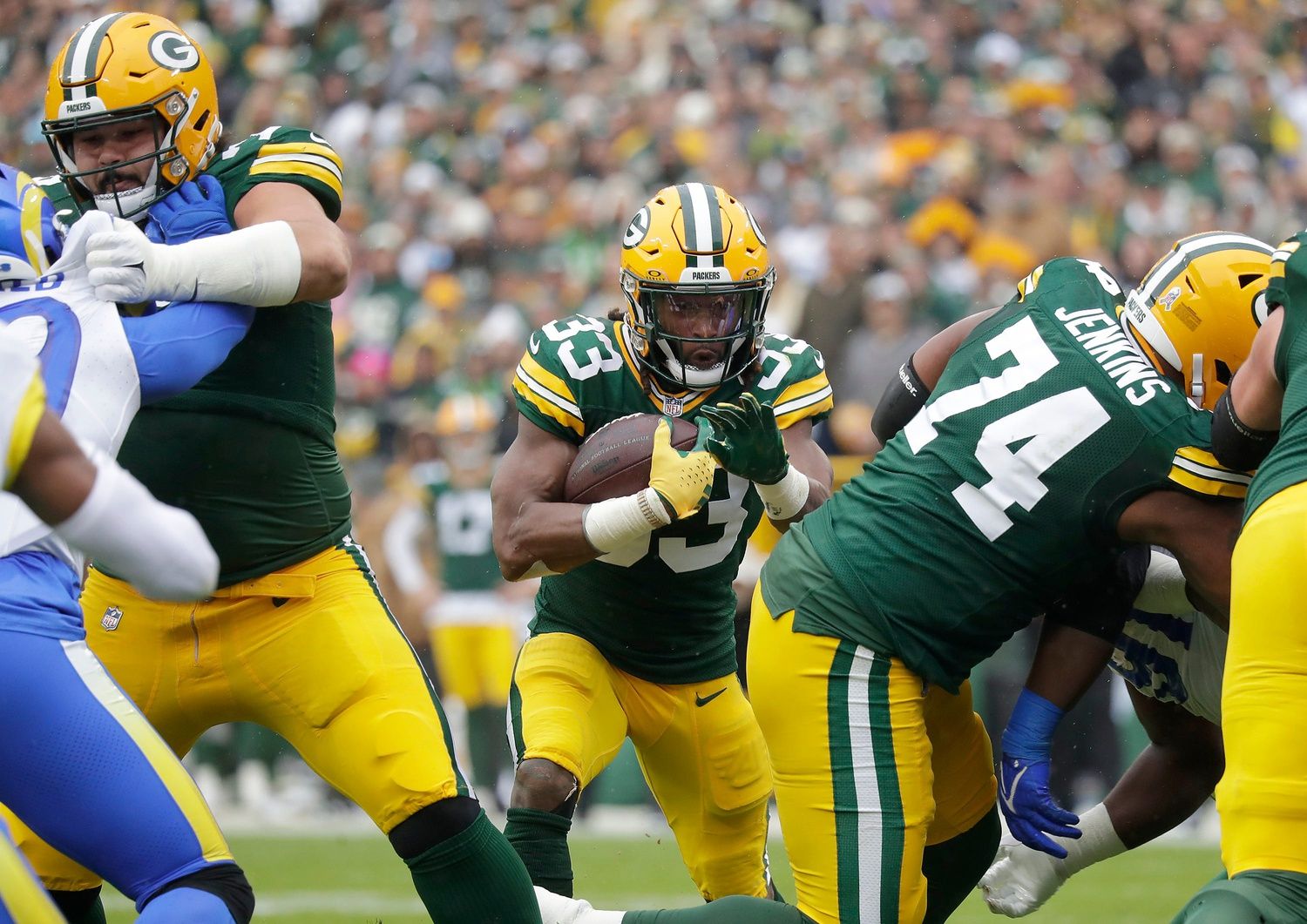 Aaron Jones (33) rushes against the Los Angeles Rams during their football game.