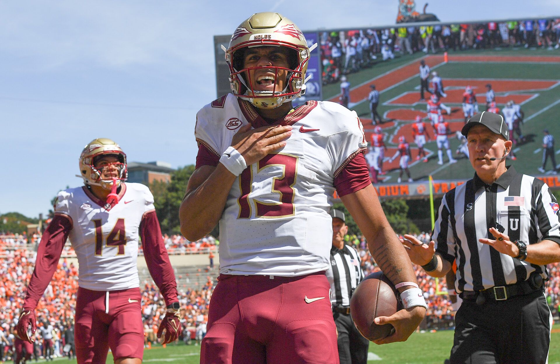 Florida State Seminoles quarterback Jordan Travis (13) reacts after scoring against the Clemson Tigers during the second quarter at Memorial Stadium.