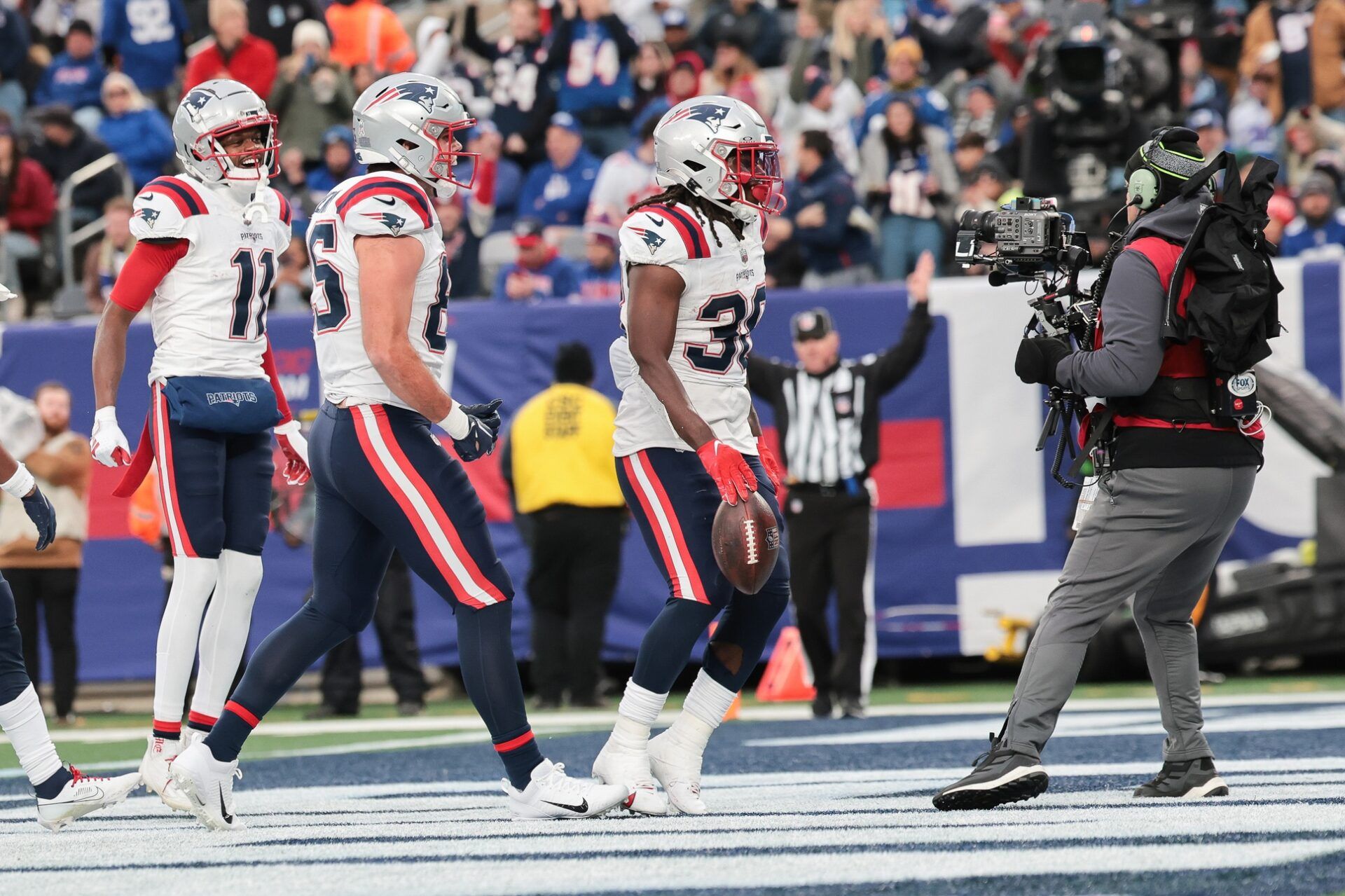 New England Patriots running back Rhamondre Stevenson (38) celebrates his rushing touchdown against the New York Giants during the second half at MetLife Stadium.