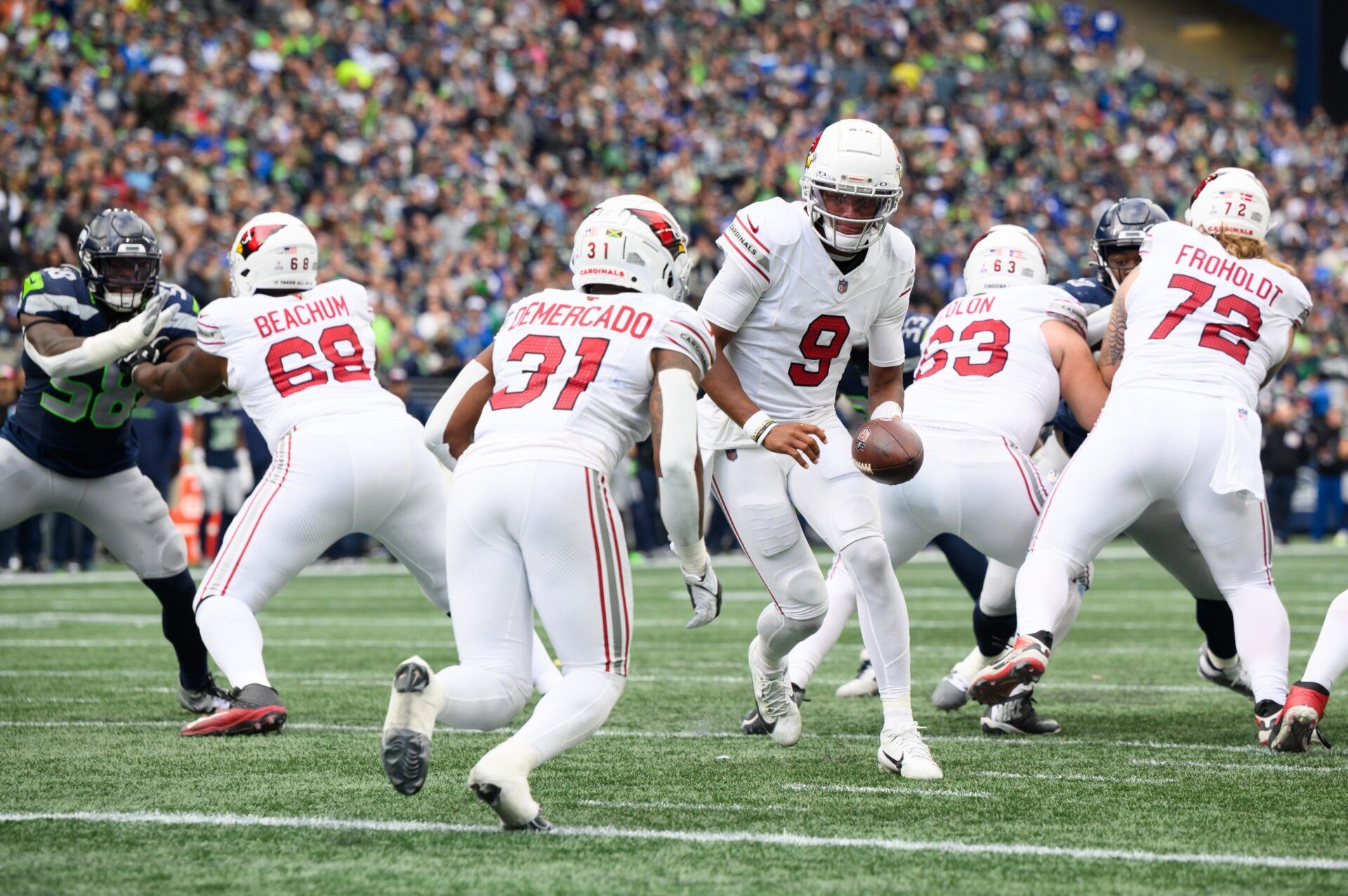 Arizona Cardinals QB Joshua Dobbs (9) hands the ball off to RB Emari Demercado (31).