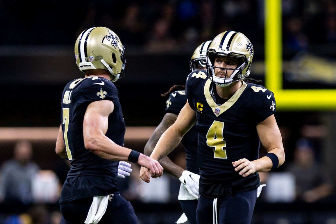 New Orleans Saints quarterback Derek Carr (4) talks to quarterback Taysom Hill (7) against the Detroit Lions during the first half at the Caesars Superdome.