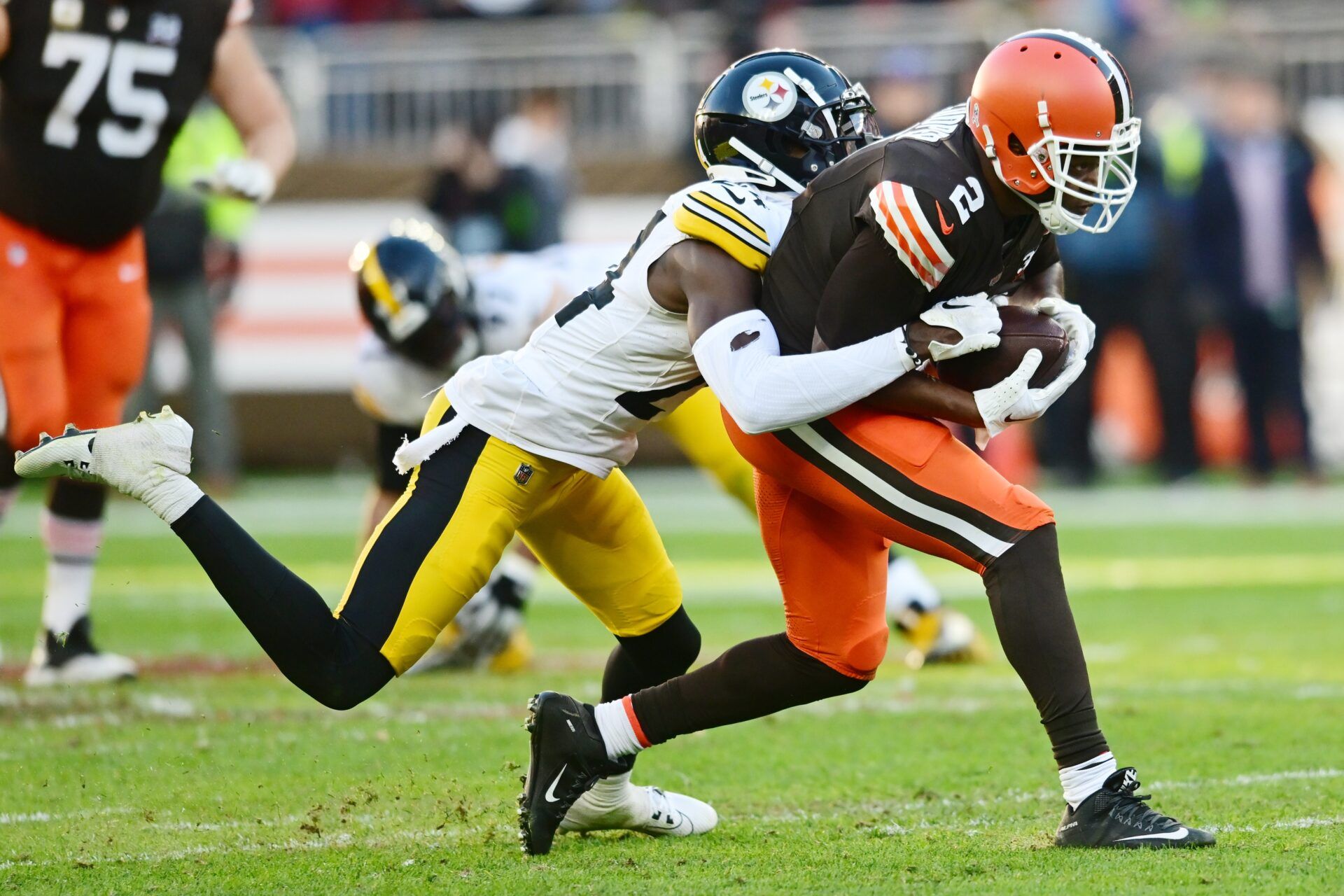 Pittsburgh Steelers cornerback Joey Porter Jr. (24) tackles Cleveland Browns wide receiver Amari Cooper (2) during the second half at Cleveland Browns Stadium.