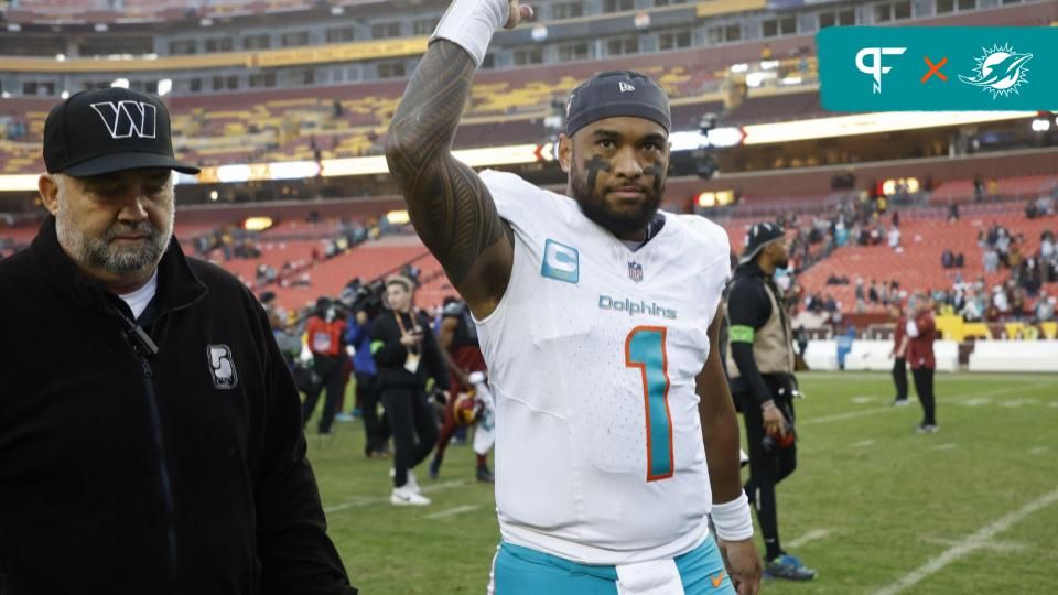 Miami Dolphins quarterback Tua Tagovailoa (1) waves to fans while leaving the field after the Dolphins' game against the Washington Commanders at FedExField.