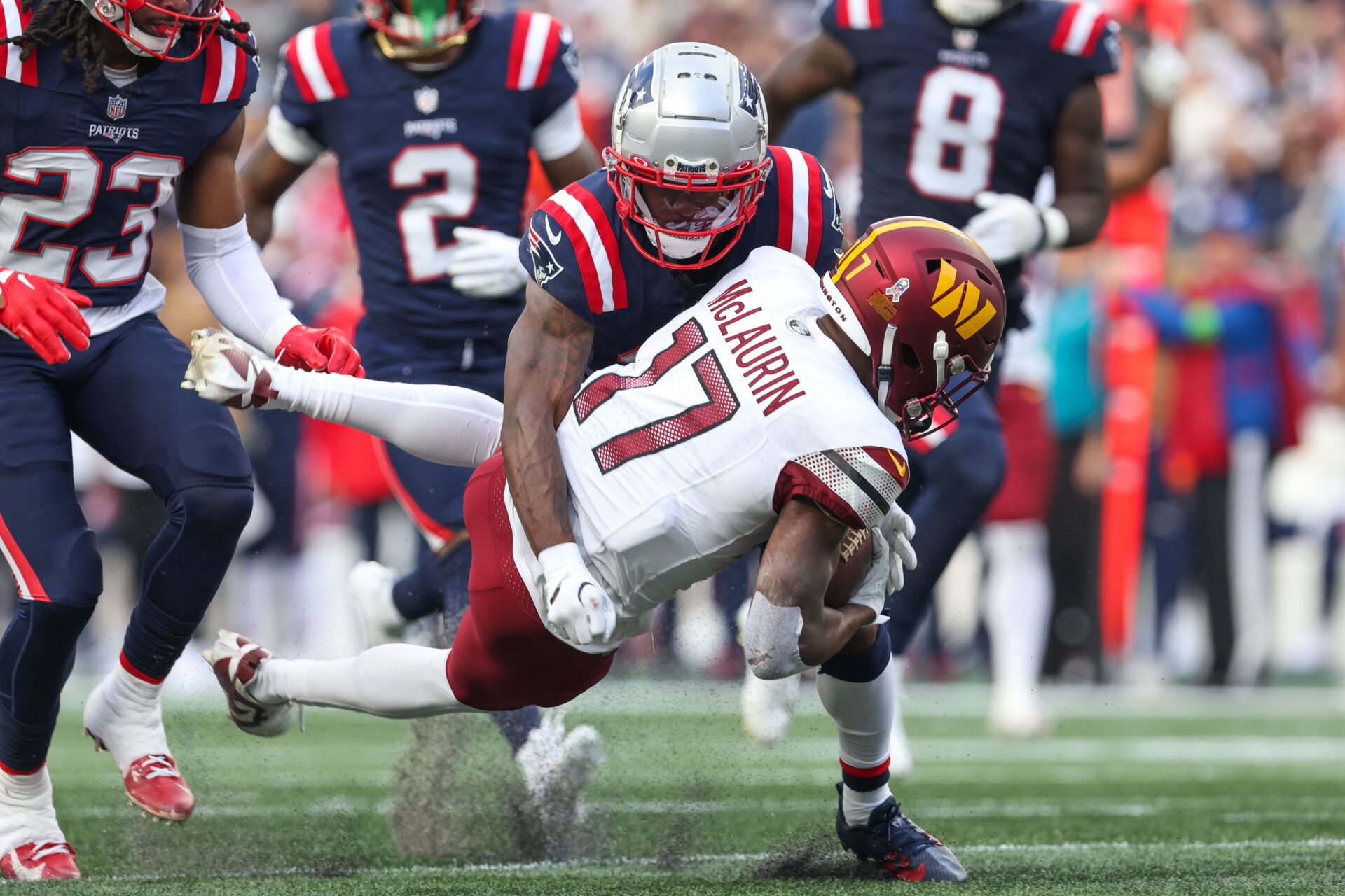 New England Patriots cornerback Jonathan Jones (31) tackles Washington Commanders receiver Terry McLaurin (17) during the second half at Gillette Stadium.