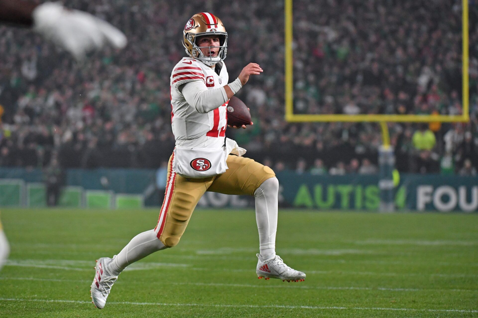 Brock Purdy (13) carries the football against the Philadelphia Eagles during the second quarter at Lincoln Financial Field.