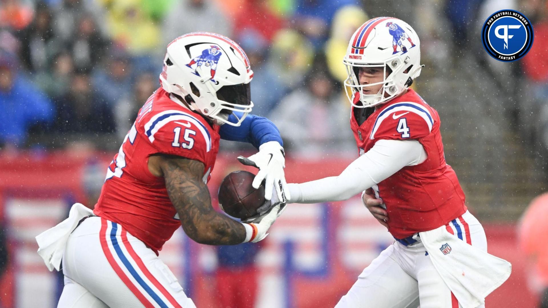 New England Patriots quarterback Bailey Zappe (4) hands the ball off to running back Ezekiel Elliott (15) during the first half at Gillette Stadium.