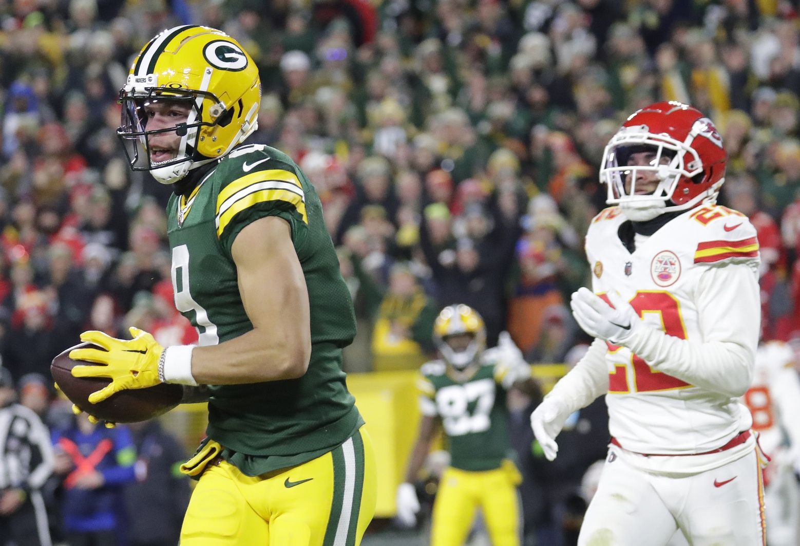 Green Bay Packers wide receiver Christian Watson (9) scores a touchdown against Kansas City Chiefs cornerback Trent McDuffie (22) at Lambeau Field.