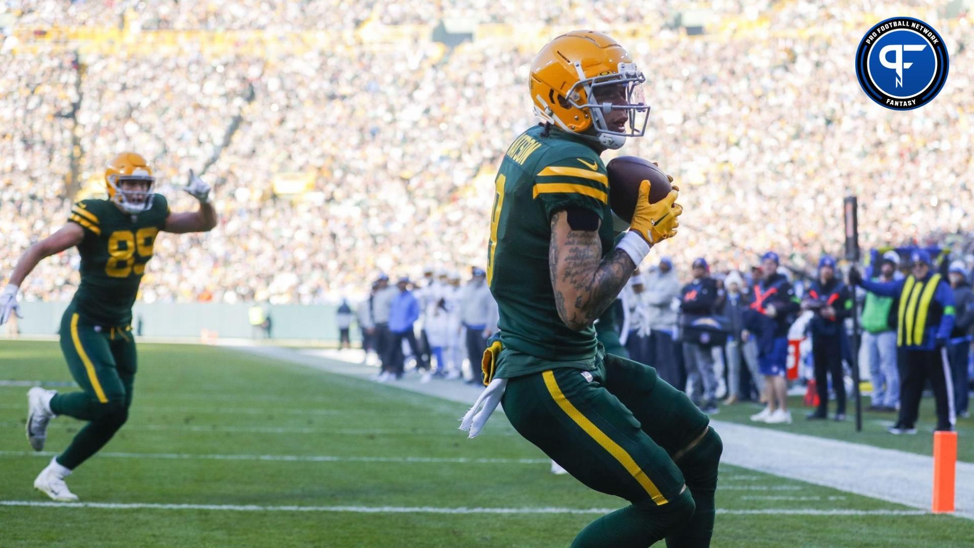 Christian Watson (9) catches a touchdown pass against the Los Angeles Chargers during the game at Lambeau Field.