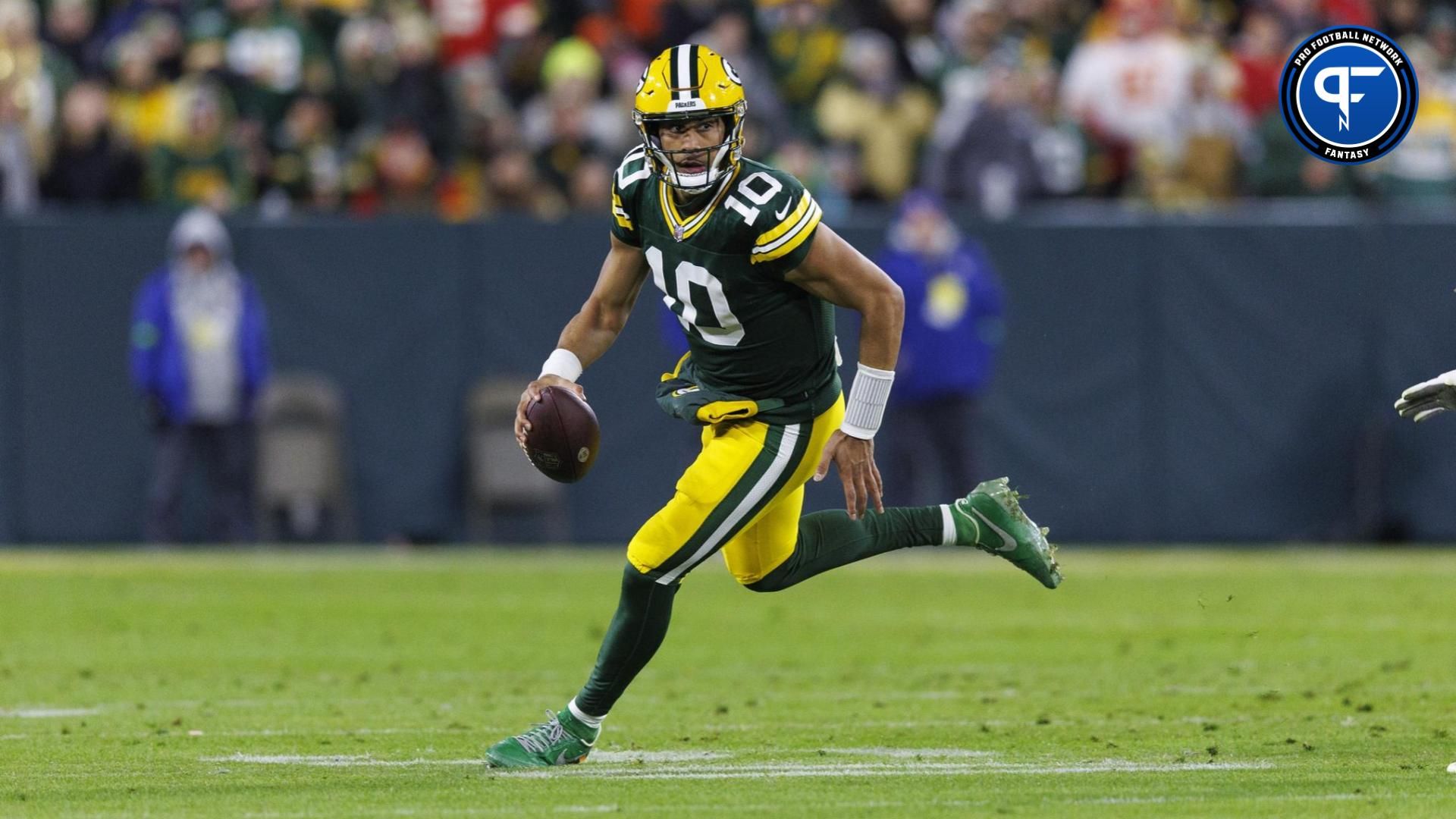 Green Bay Packers quarterback Jordan Love (10) rushes with the football during the second quarter against the Kansas City Chiefs.