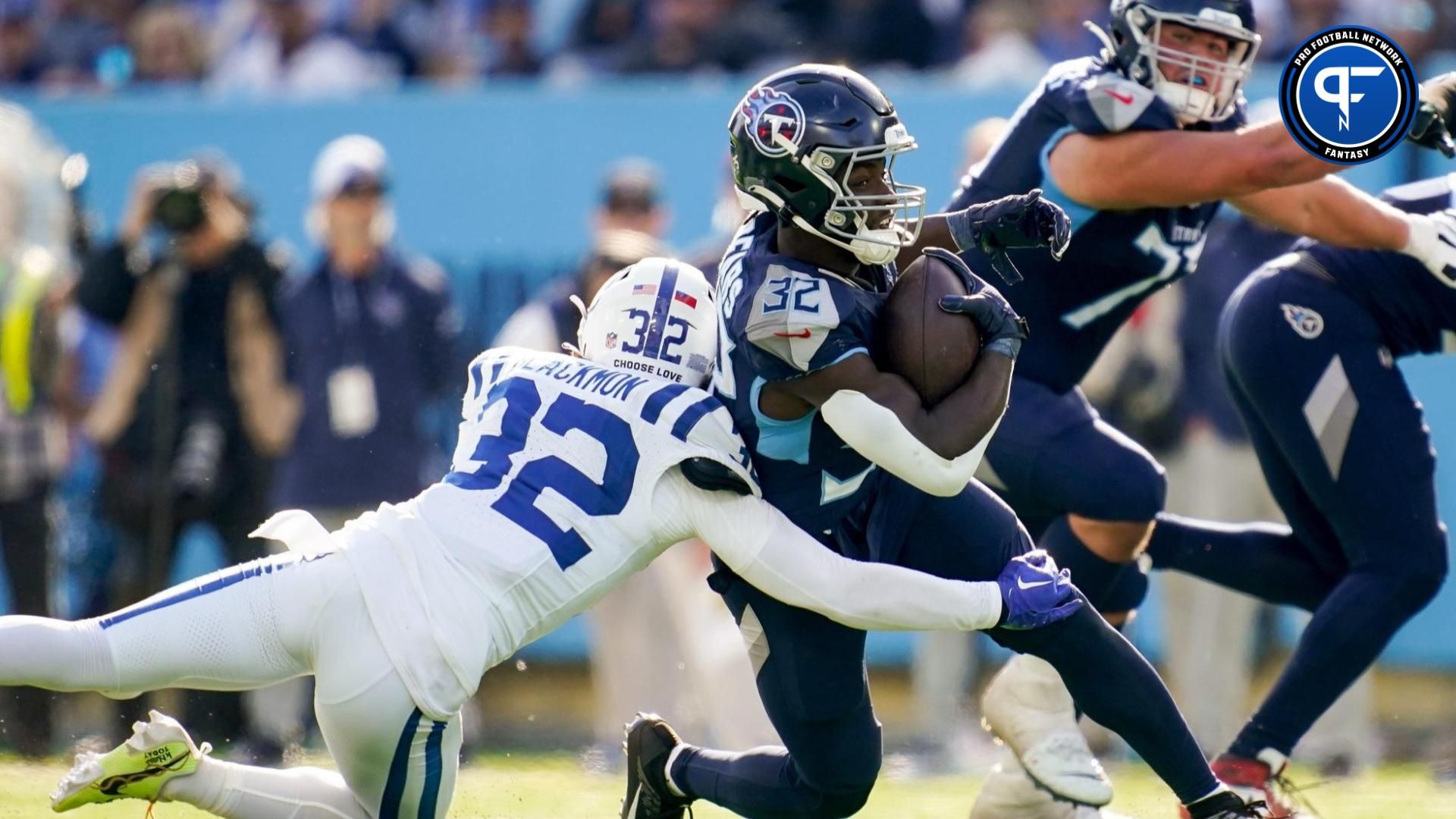 Tennessee Titans running back Tyjae Spears (32) is tackled by Indianapolis Colts safety Julian Blackmon (32).