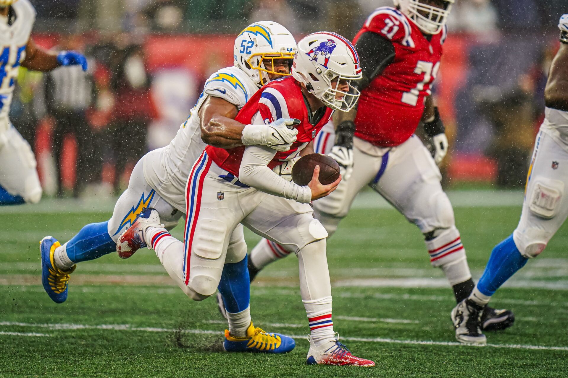 New England Patriots QB Bailey Zappe (4) gets sacked by Los Angeles Chargers LB Khalil Mack (52).