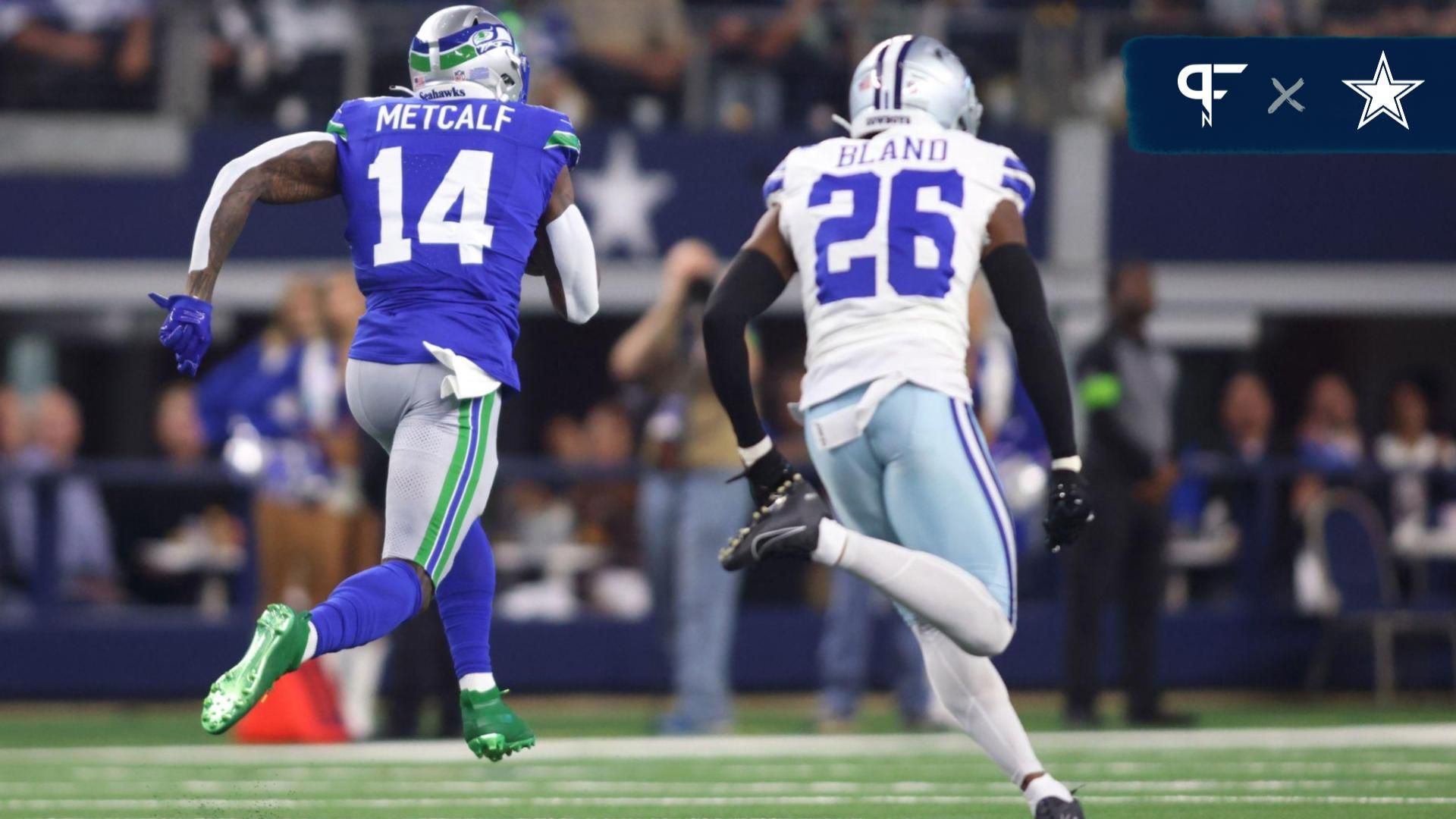 Seattle Seahawks wide receiver DK Metcalf (14) runs with the ball for a touchdown ahead of Dallas Cowboys cornerback DaRon Bland (26) during the first half at AT&T Stadium.