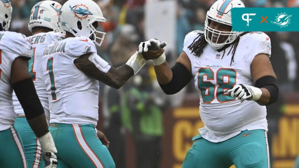 Miami Dolphins QB Tua Tagovailoa (1) and OL Robert Hunt (68) celebrate after a touchdown.