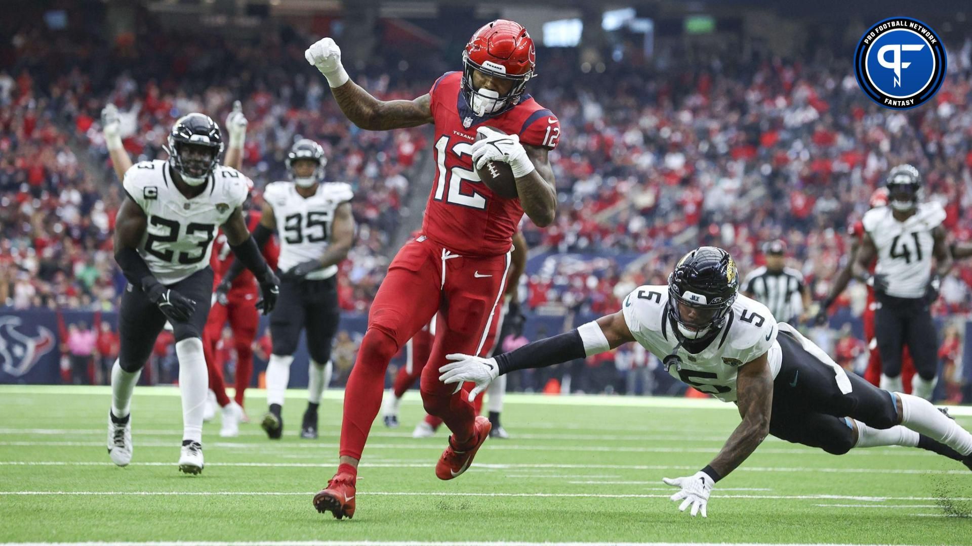 Houston Texans wide receiver Nico Collins (12) runs with the ball and scores a touchdown as Jacksonville Jaguars safety Andre Cisco (5) defends.