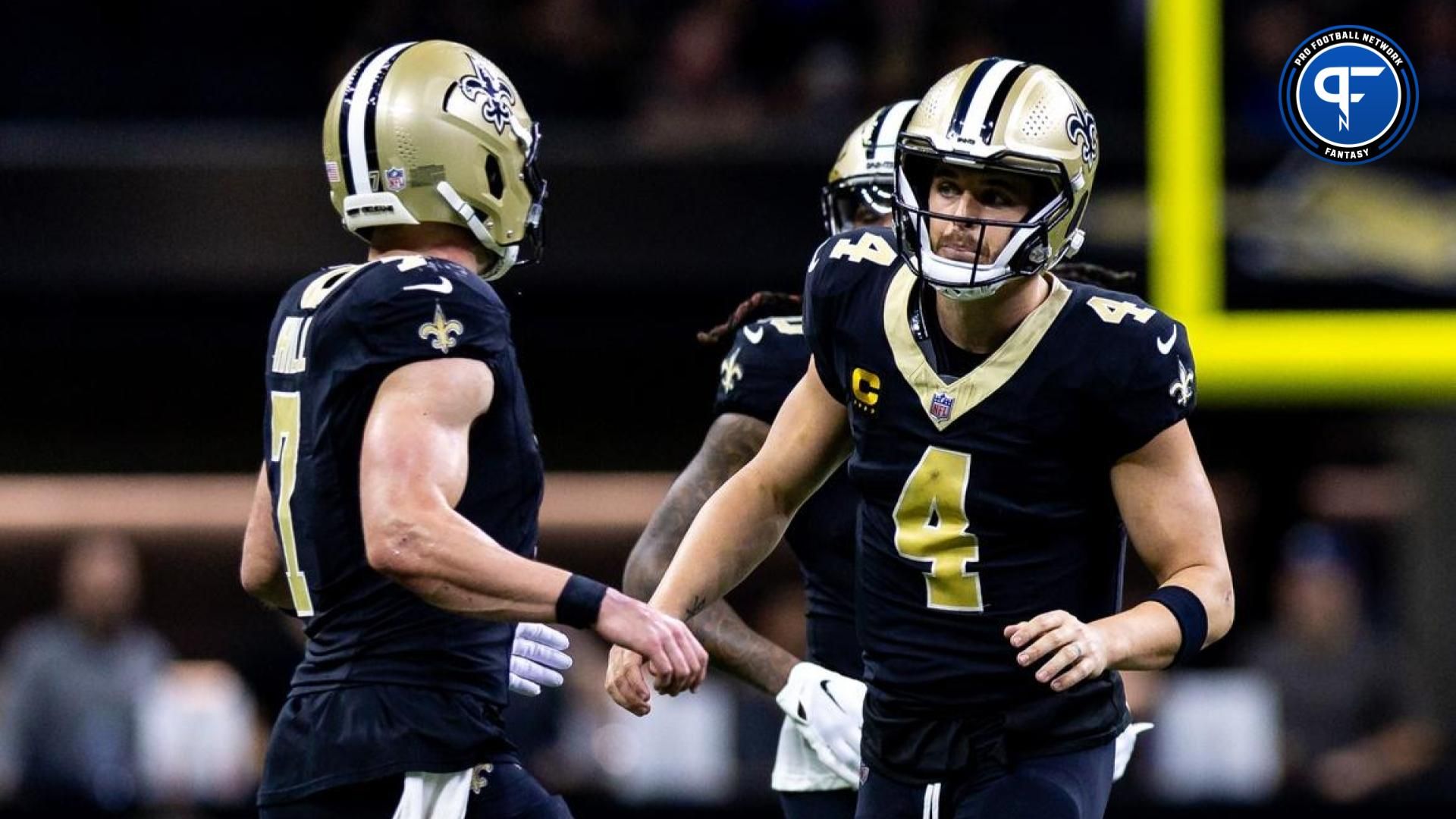 New Orleans Saints QB Derek Carr (4) talks to QB/TE Taysom Hill (7) during the game against the Detroit Lions.