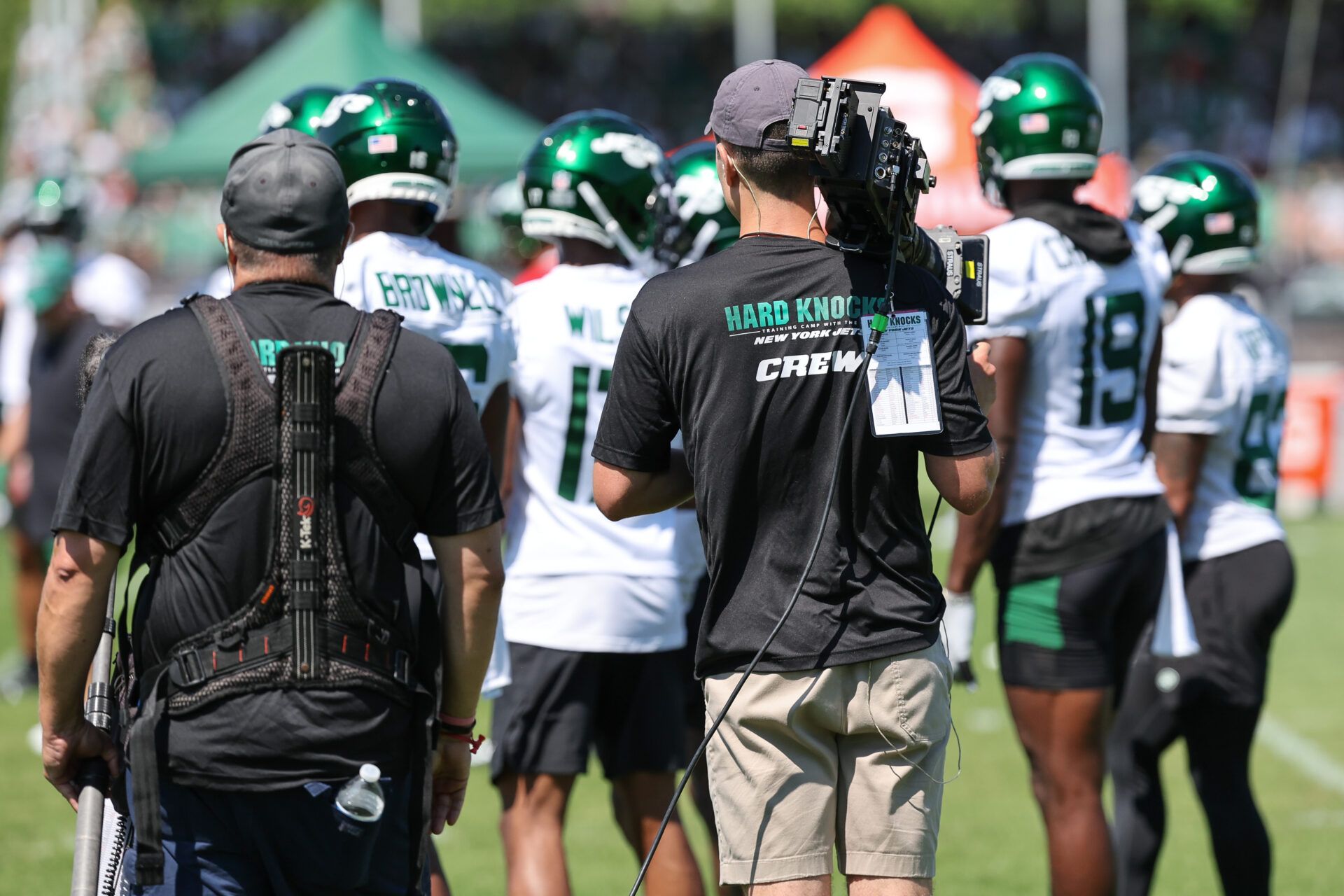 Jul 22, 2023; Florham Park, NJ, USA; An NFL Films crew for the HBO television series Hard Knocks stand behind New York Jets receivers during the New York Jets Training Camp at Atlantic Health Jets Training Center. Mandatory Credit: Vincent Carchietta-USA TODAY Sports